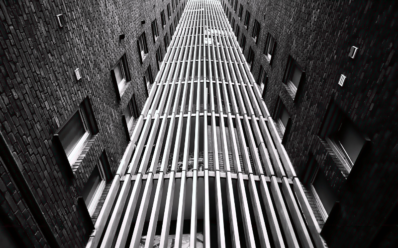 Looking straight up at a black and white grid of a Pennsylvania and New Jersey building — therapy for anxiety, burnout and emotional overwhelm, Philadelphia therapist