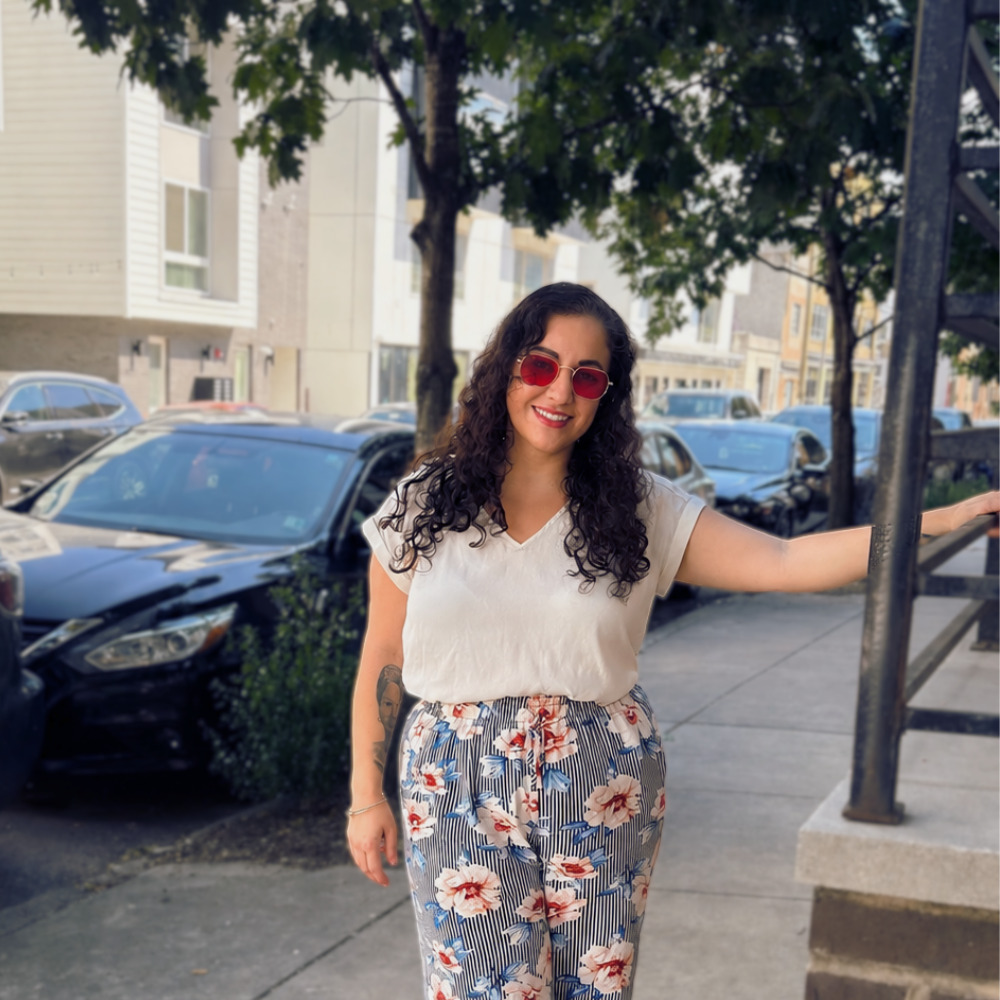 Philadelphia therapist Dana Catarella standing on a city street — founder of The Relational Space, individual and couples therapy in Philadelphia PA"
