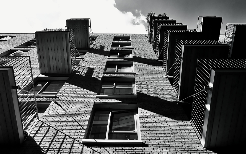 Looking up at towering black and white Philadelphia buildings — trauma therapy and emotional abuse recovery at The Relational Space Philadelphia