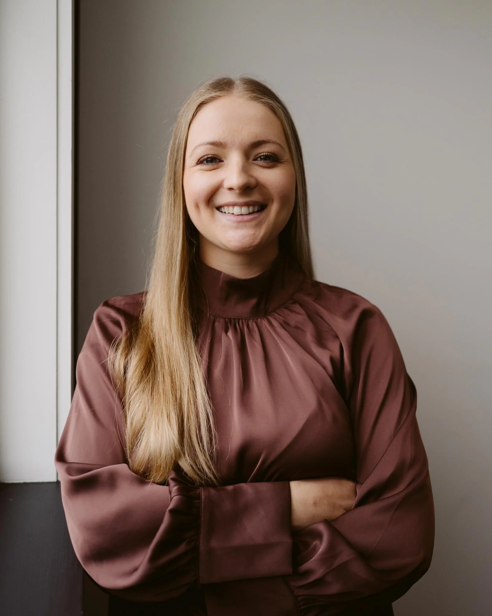 Devon Sawyer smiling with arms crossed