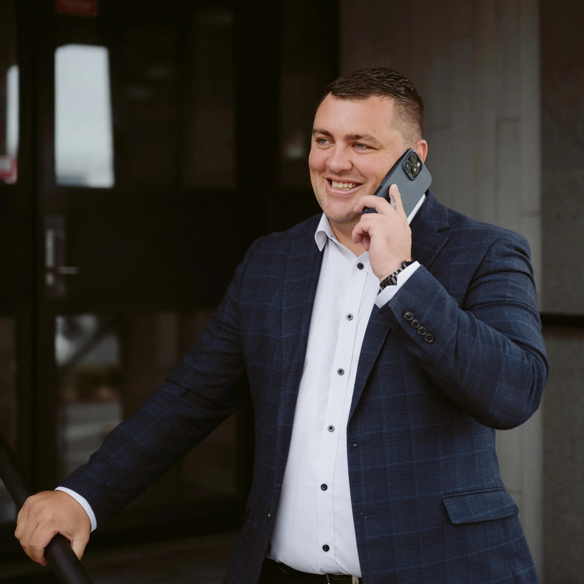 Joey standing outside while talking on the phone