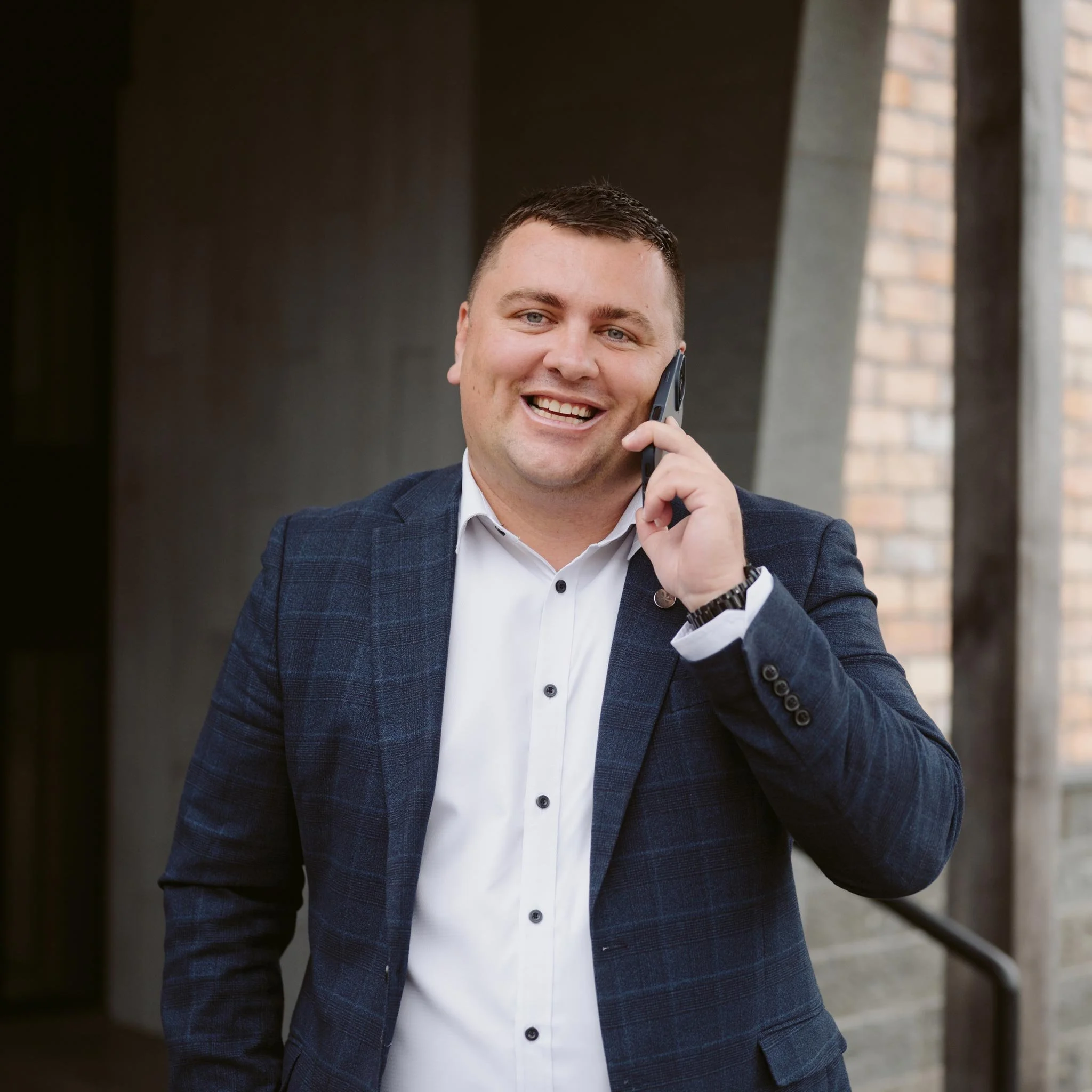 Joey Gregory smiling while talking on the phone