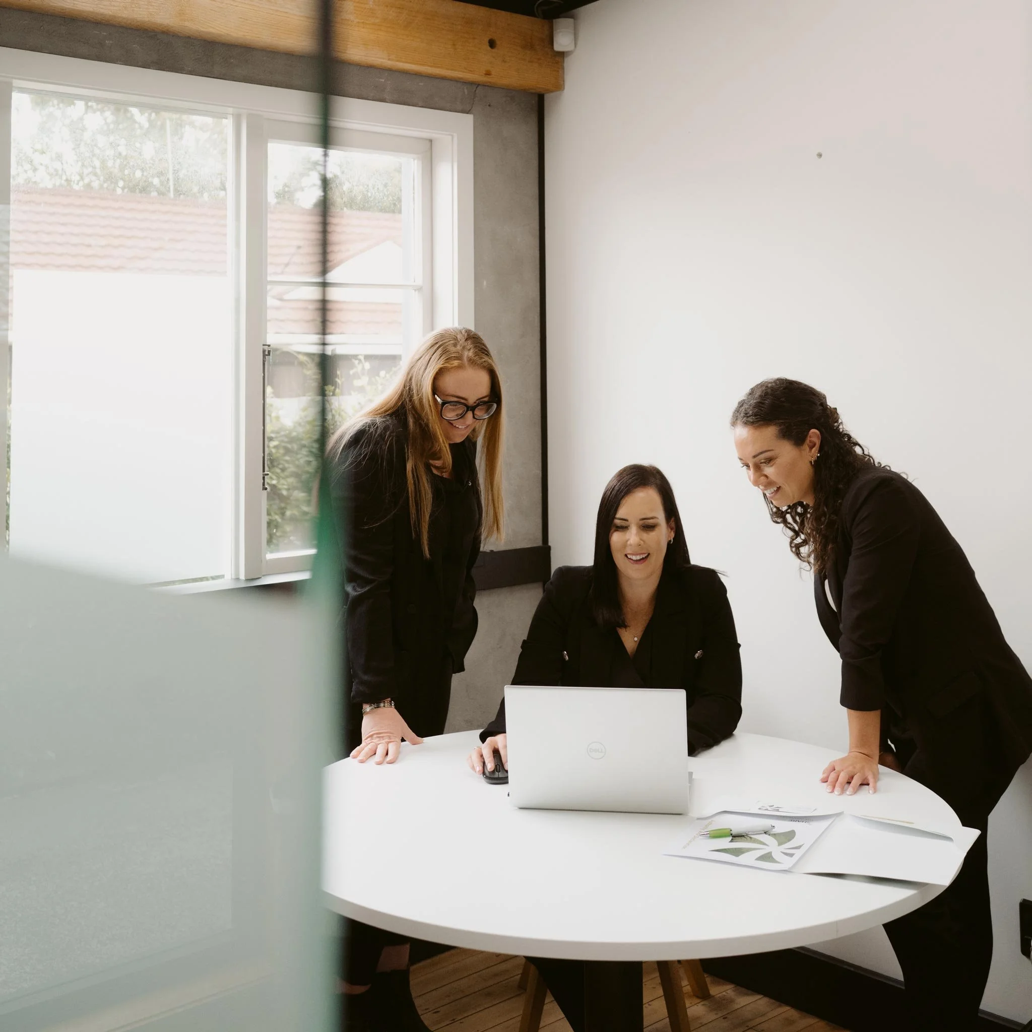 Aliesha, Claire and Shannen looking at a laptop