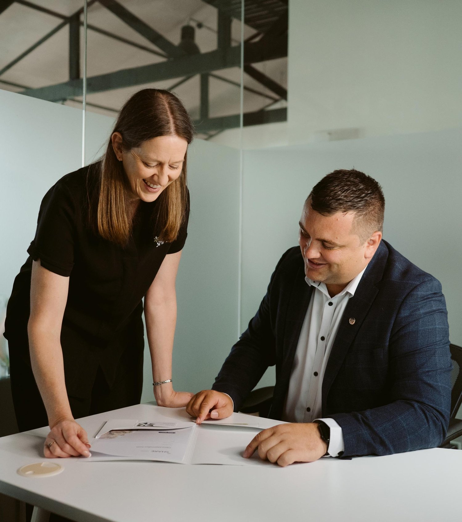 An adviser going through paperwork with a client.