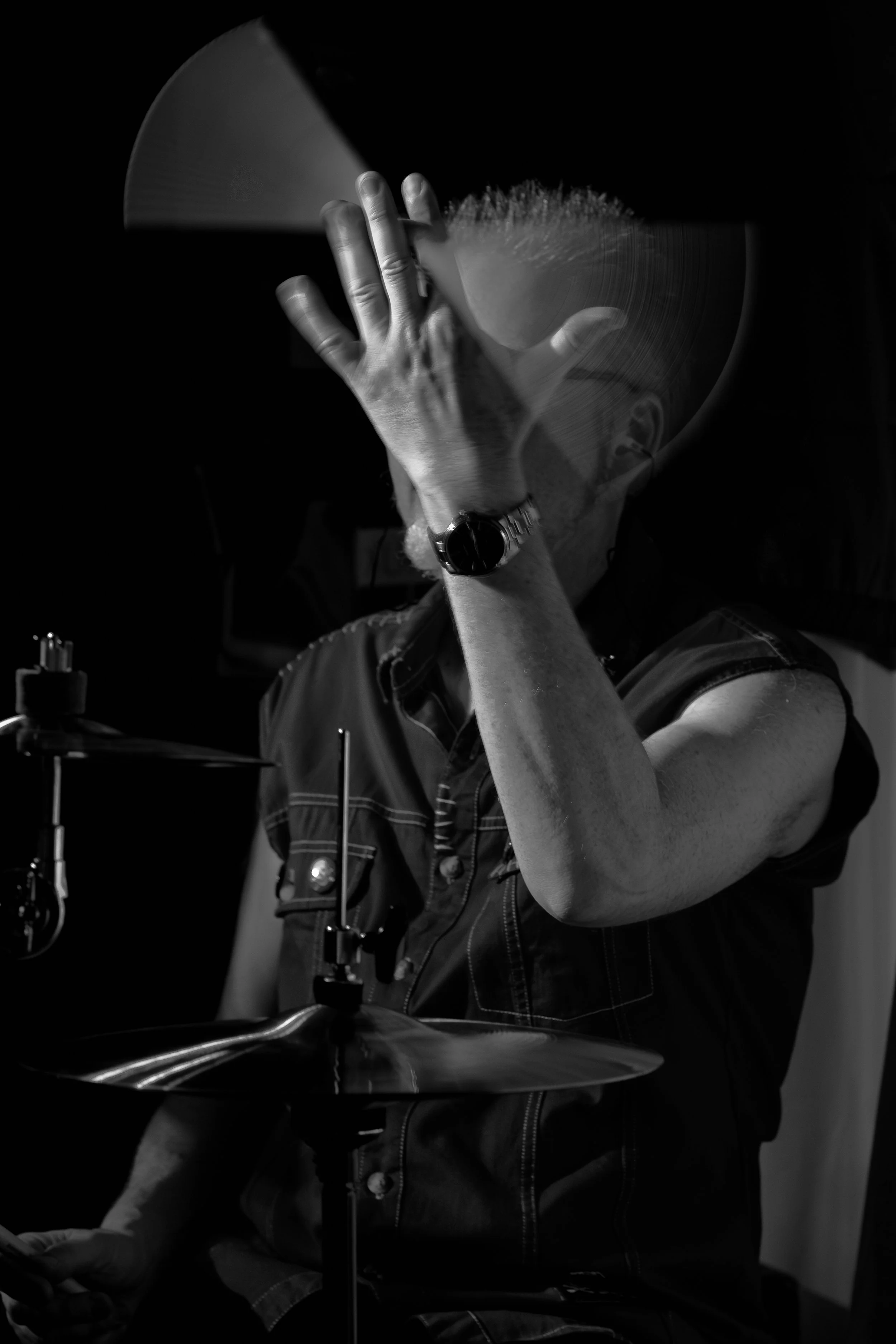 David Millgate of Lodestone Pirates, twirling the drumsticks at The Donkey, Leicester. 28th July 2023. Fujifilm X-H1, XF90mm, 1/15, f4.5, ISO 2500. Live music photography black and white b&w Chris Tweed