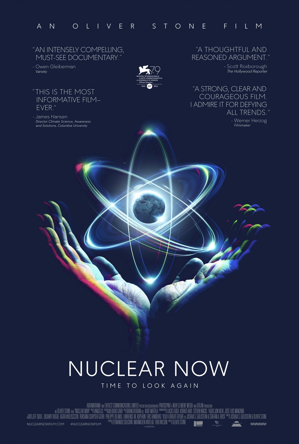 Poster for the documentary film "Nuclear Now" featuring a digital illustration of a pair of hands holding a glowing globe with neon-colored atomic orbitals surrounding it.