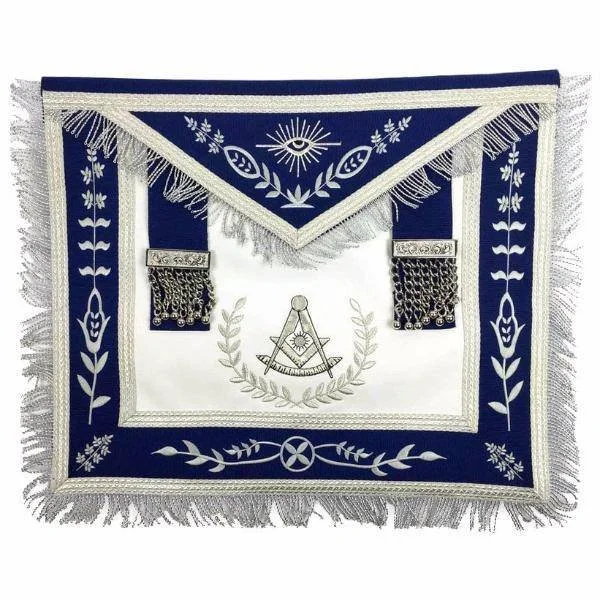 A decorative textile piece with Masonic symbols, including a compass and square, set against a white and dark blue background with floral patterns and tassels.