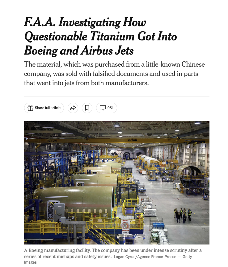 View of a Boeing aircraft manufacturing facility with large airplane fuselage sections and manufacturing equipment inside a spacious, industrial hangar.