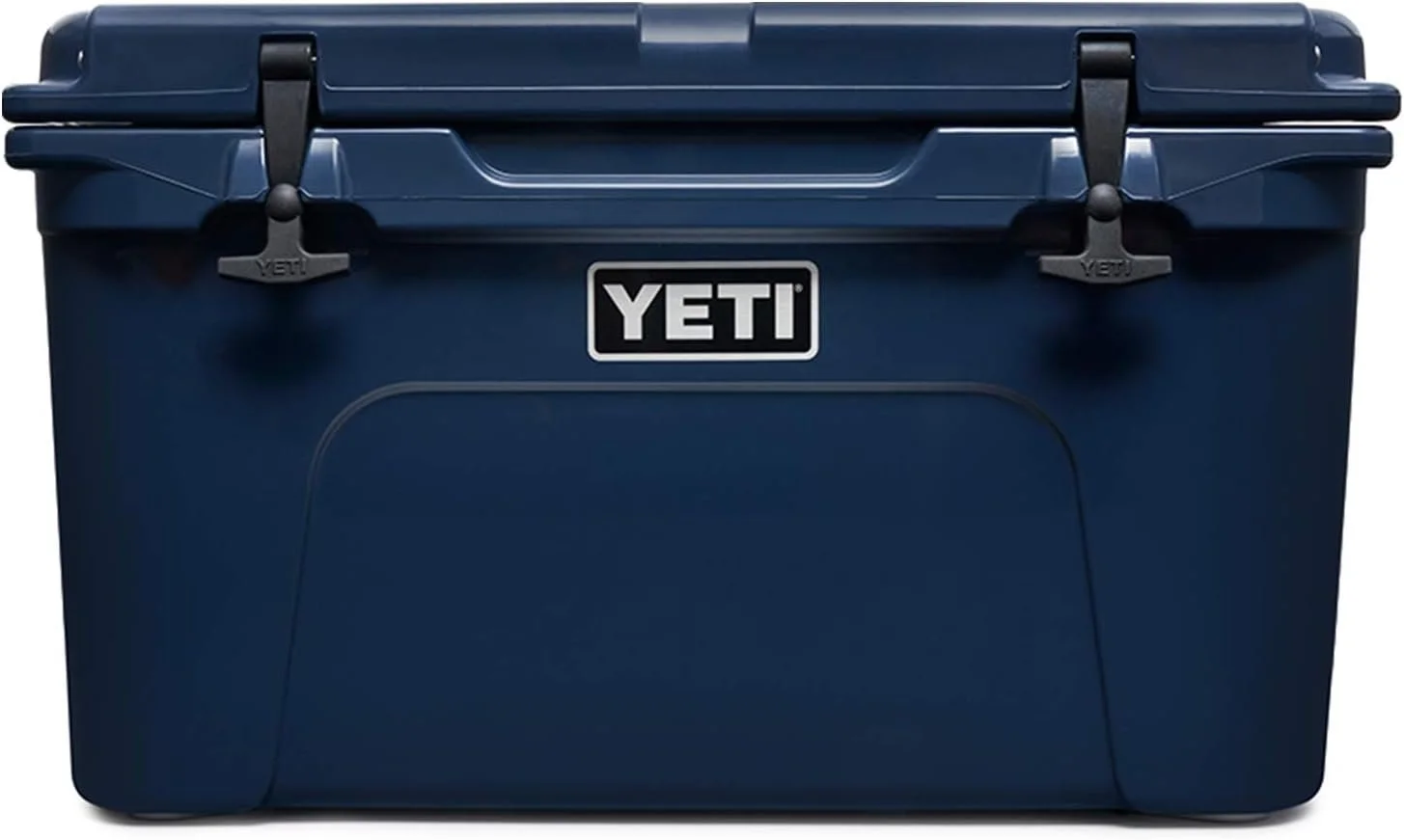A navy blue YETI cooler with black latches and a handle on the lid.