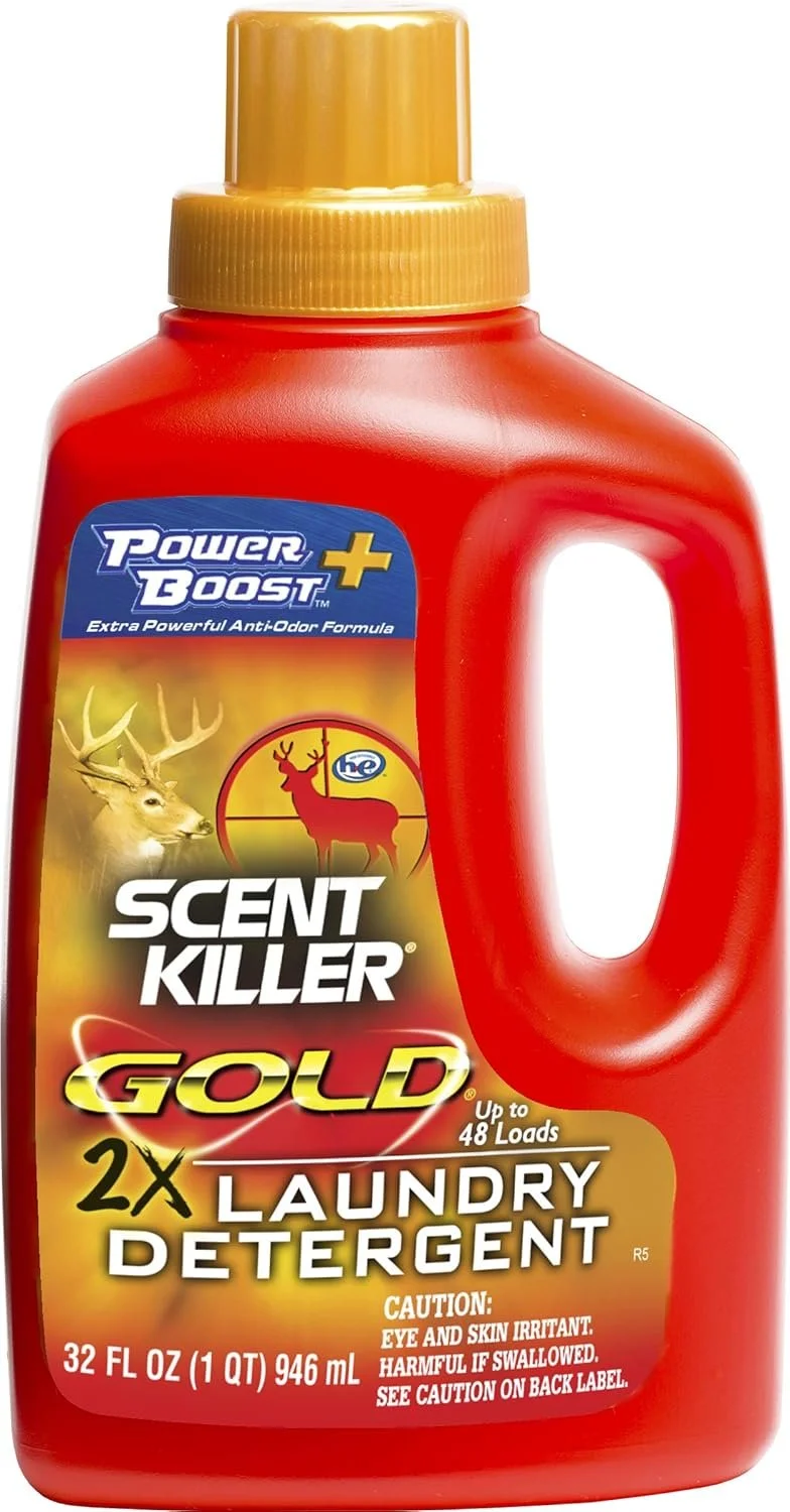 A red bottle of Scent Killer Gold laundry detergent with a yellow cap, featuring images of a deer and a hunting scope, and text indicating it is for odor control and can handle up to 48 loads.