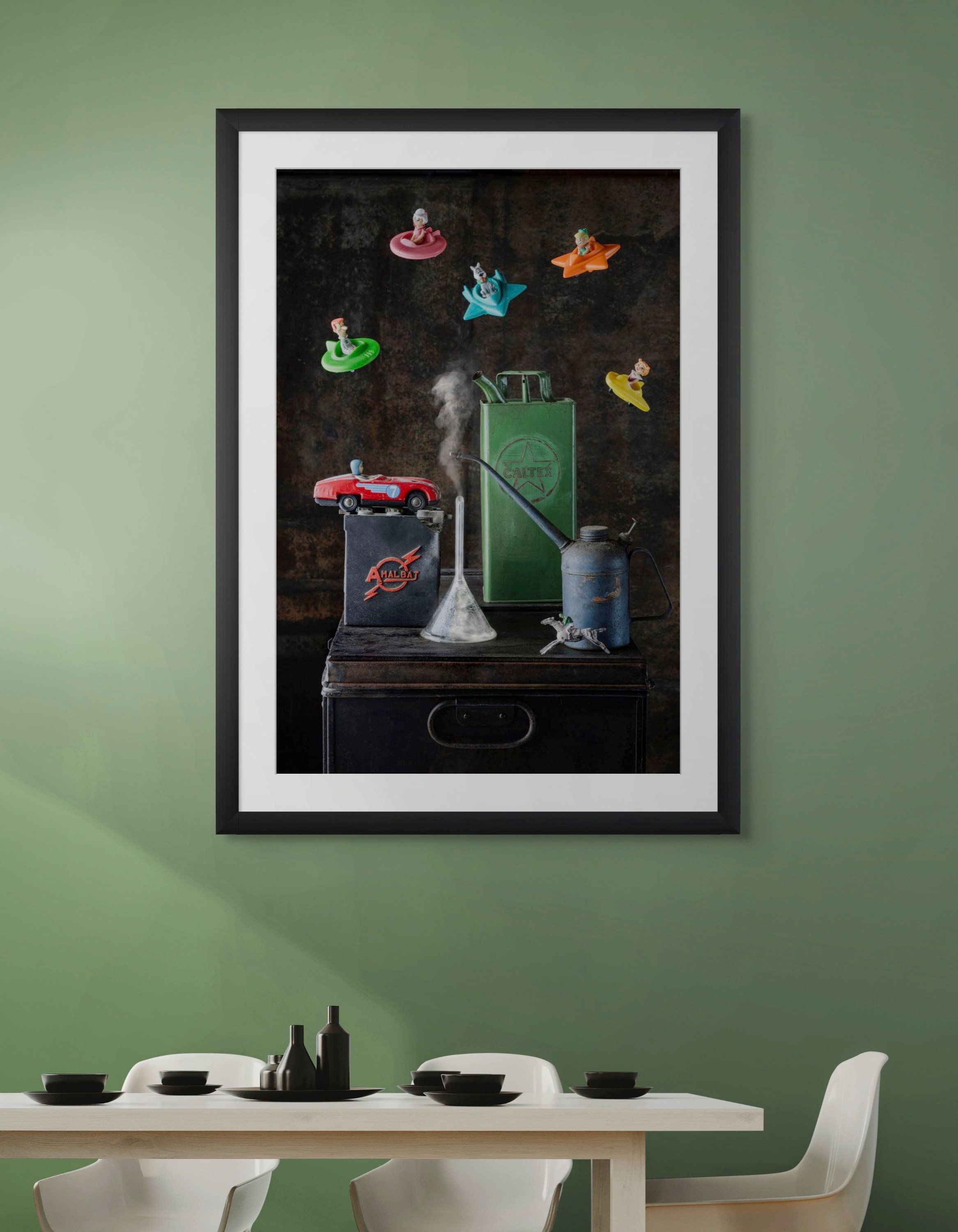 Still life of vintage science lab setup with toy cars, a beaker, a metal container, and small figurines on surfaces, with wall-mounted figurines floating above