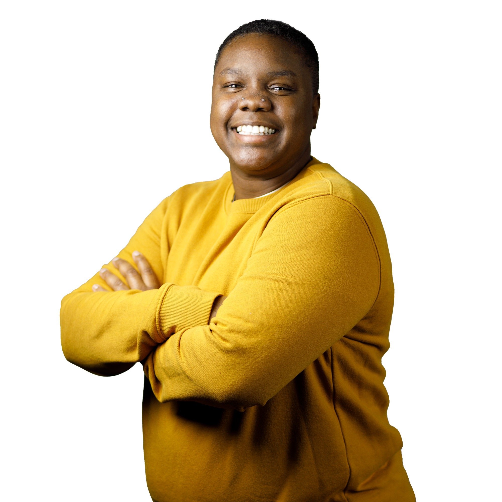 A woman smiling at the camera with a long sleeve yellow long sleeve shirt