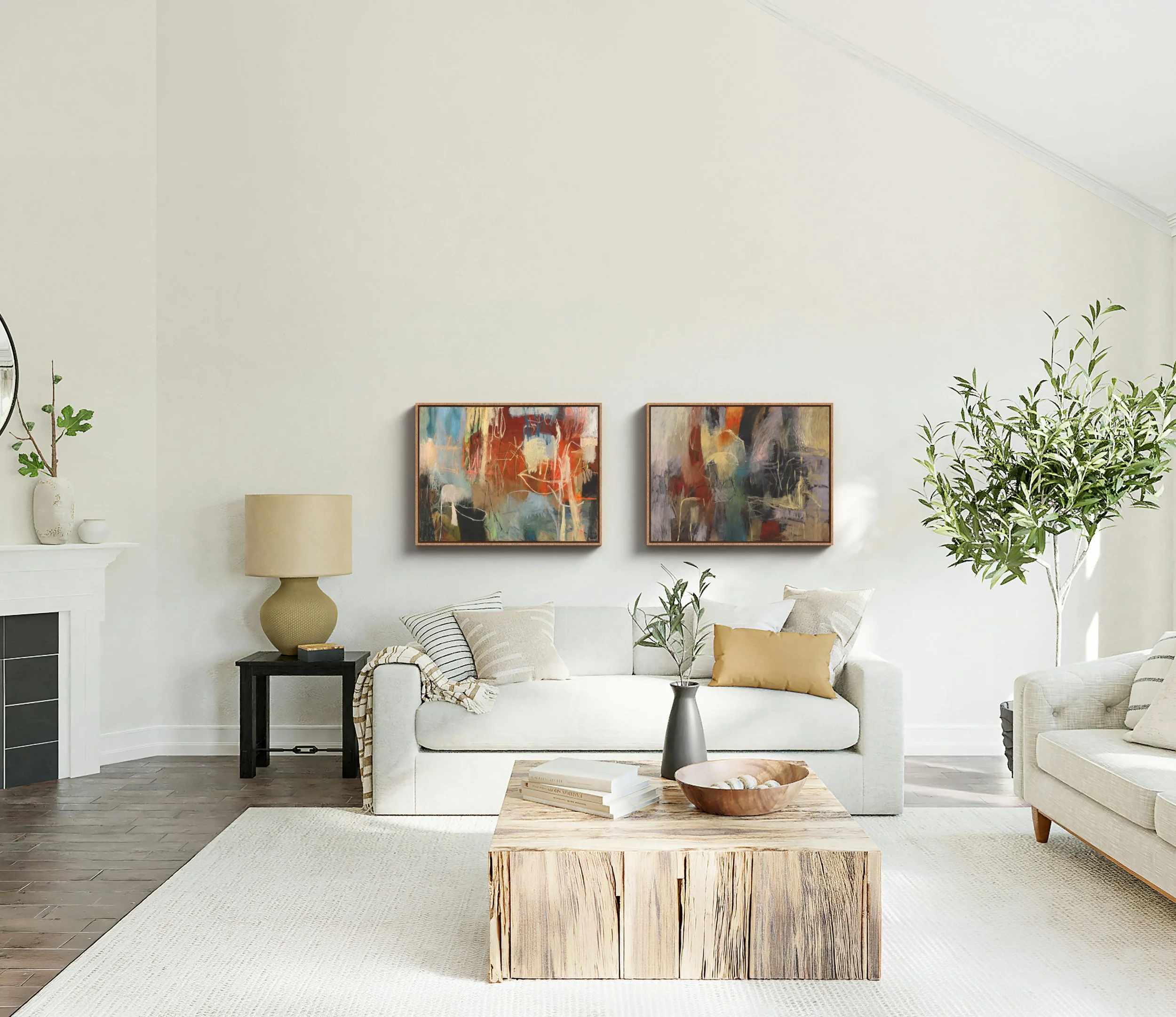 Living room with white sofa, two abstract paintings on the wall, a beige lamp, and a wooden coffee table with books and a decorative bowl, with green plants nearby.
