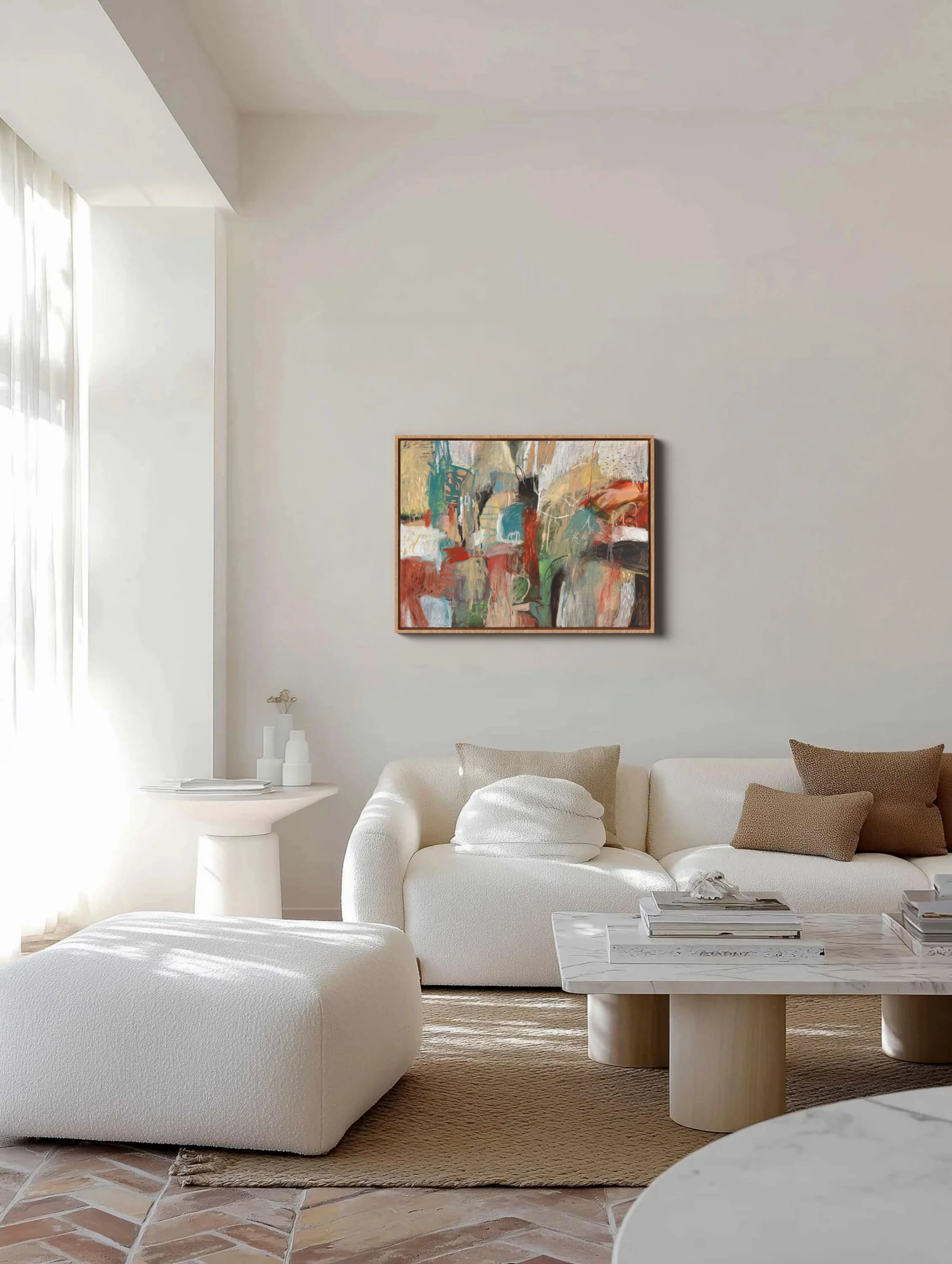 Bright living room with white sofa, coffee table, colorful abstract artwork, and neutral decor.