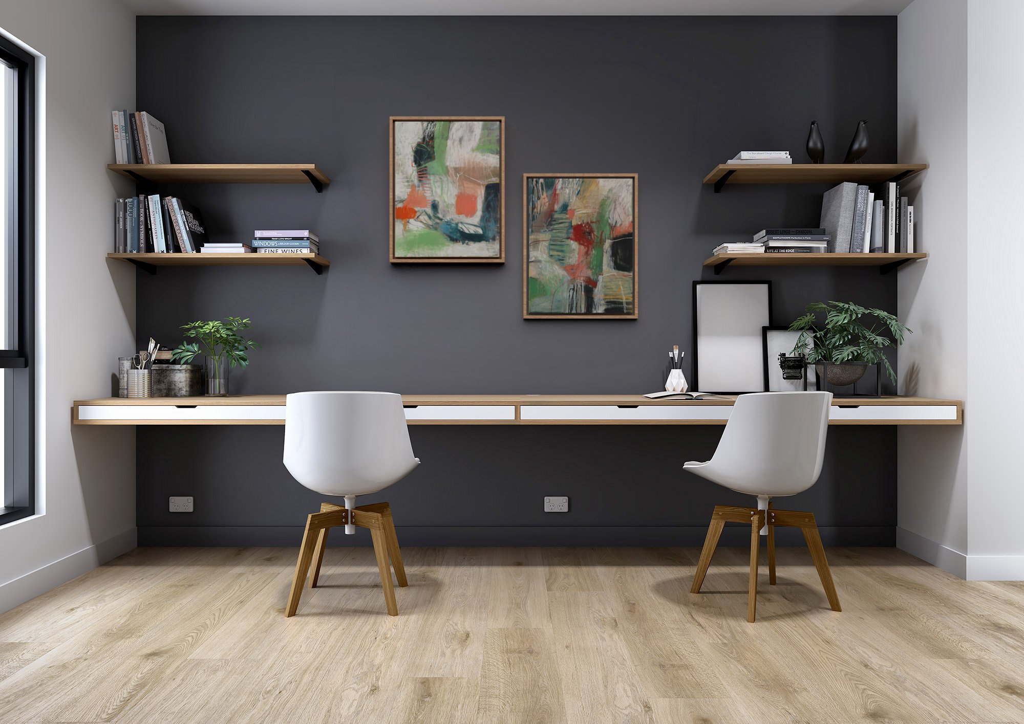 Contemporary home office with a dark accent wall, floating wooden shelves with books and decorative items, two white chairs with wooden legs, a long wooden desk, framed abstract art pieces, potted plants, and framed artwork on the desk.