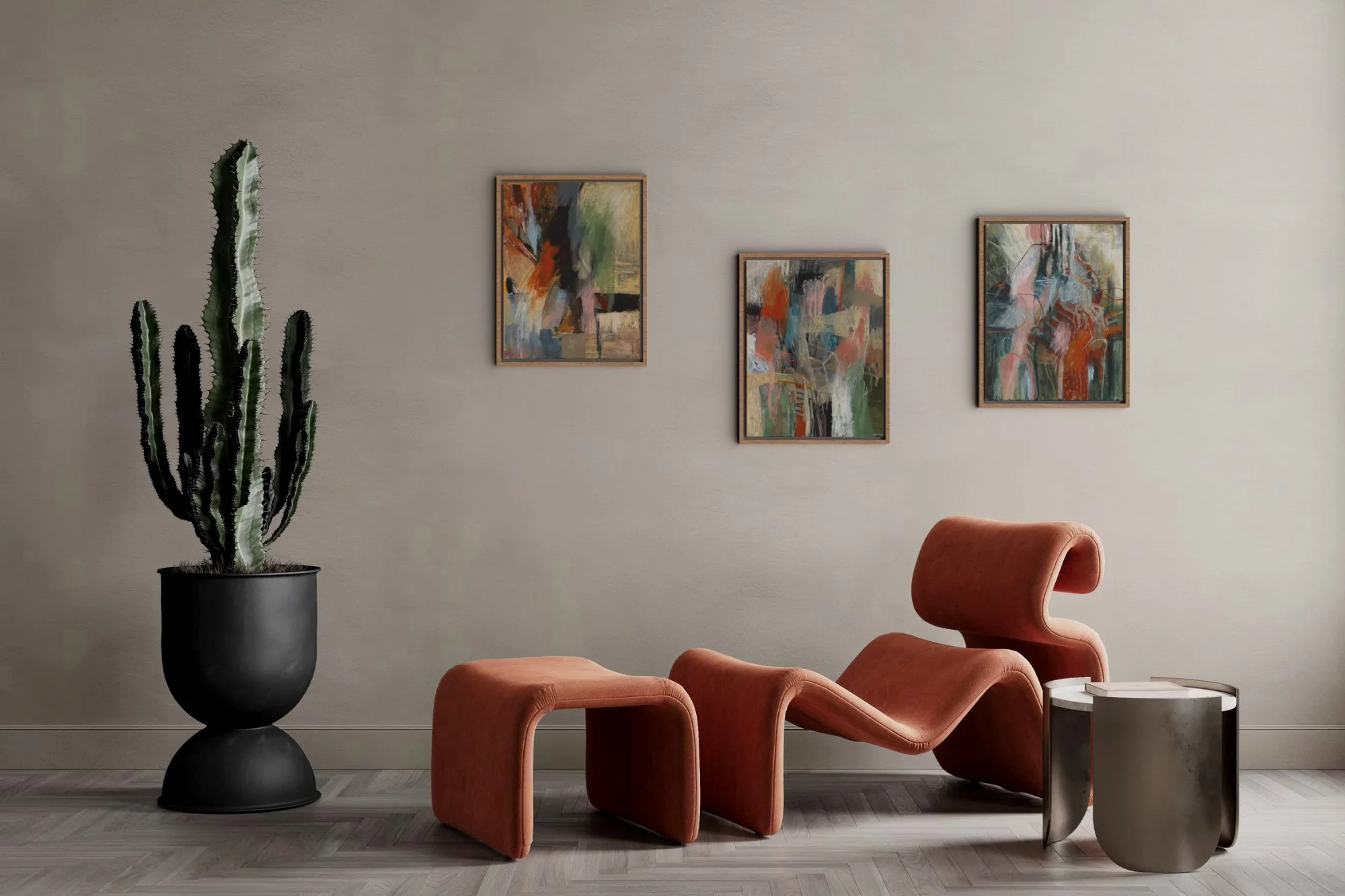 Contemporary living room with abstract artwork, a tall cactus in a black pot, a burnt orange lounge chair, and a small side table.
