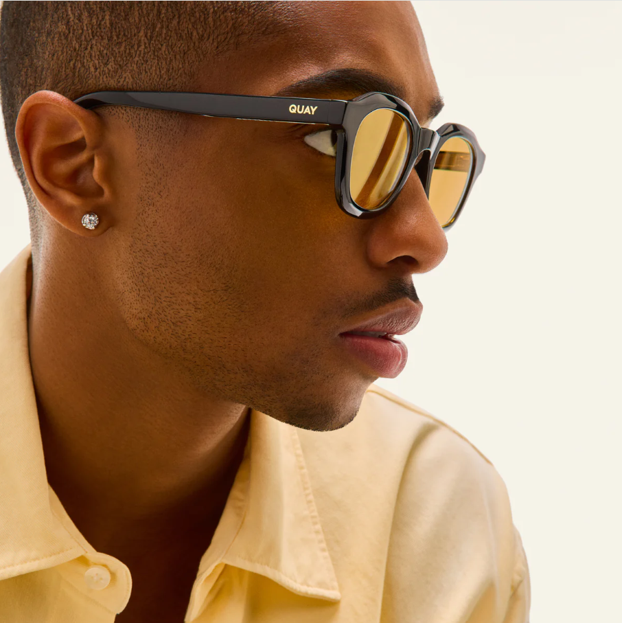 Side-profile view of model wearing Quay sunglasses
