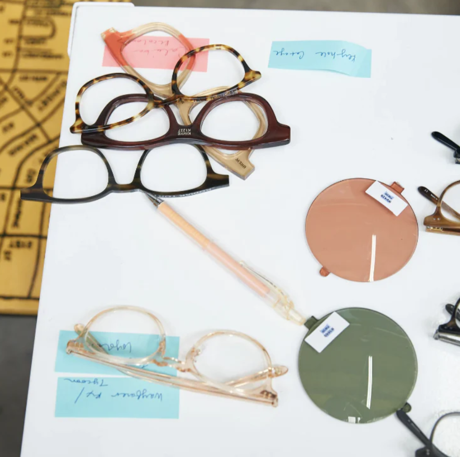 Design table featuring Garrett Leight Eyewear frames and lenses