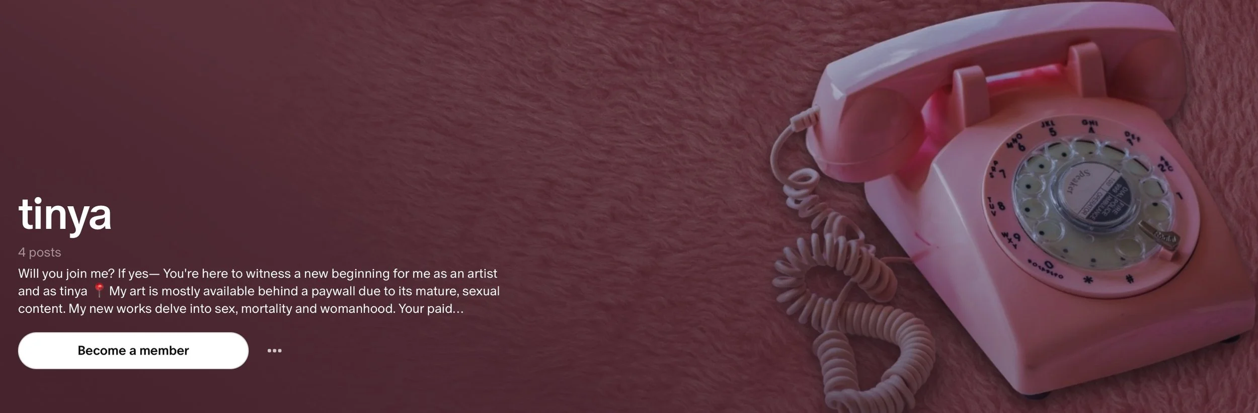 A pink rotary dial telephone resting on a pink textured surface.