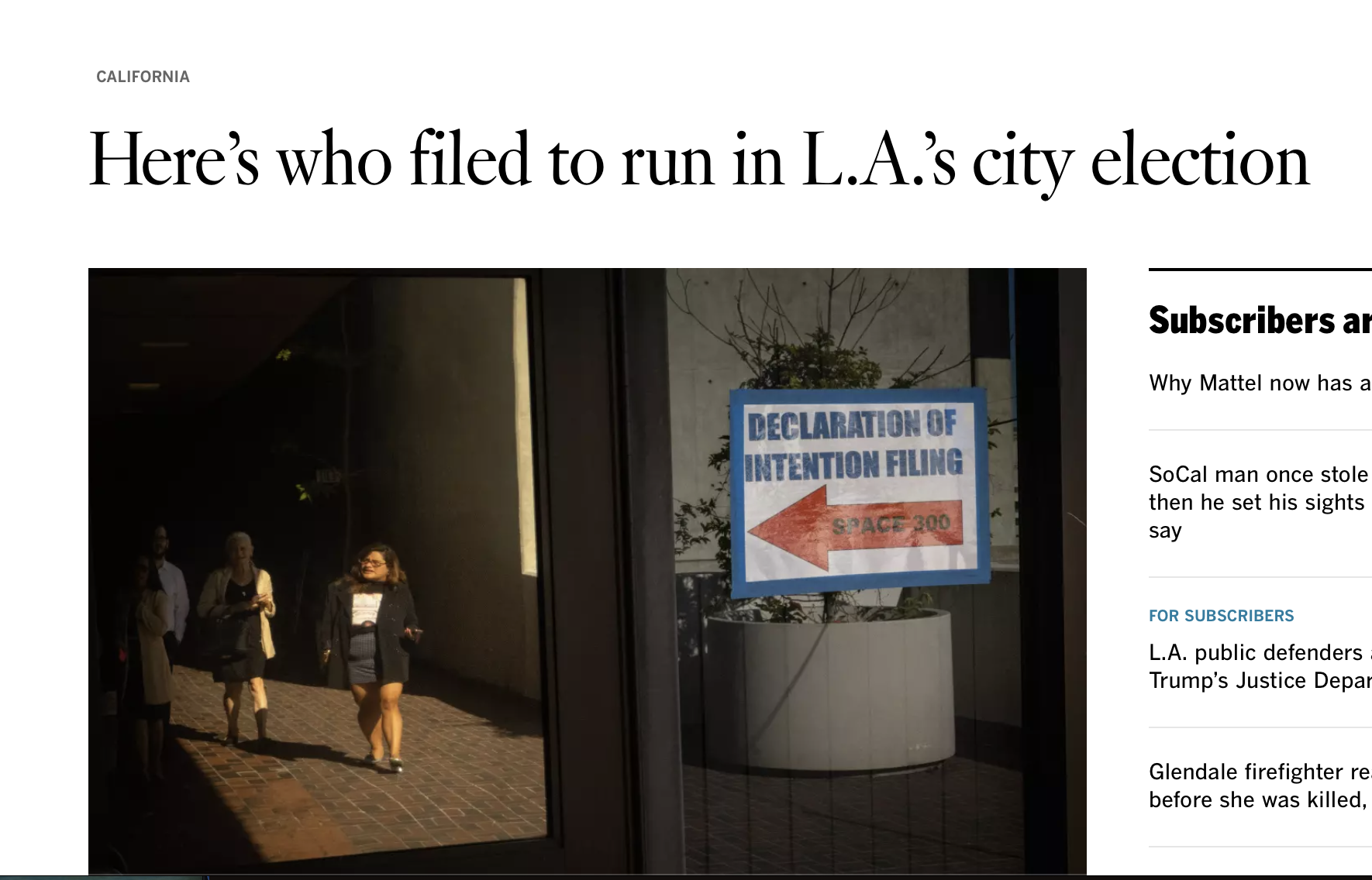 A group of people walking inside a building with a sign on the window that reads 'Declaration of Intention Filing' with an arrow pointing left and the label 'Space 300'.