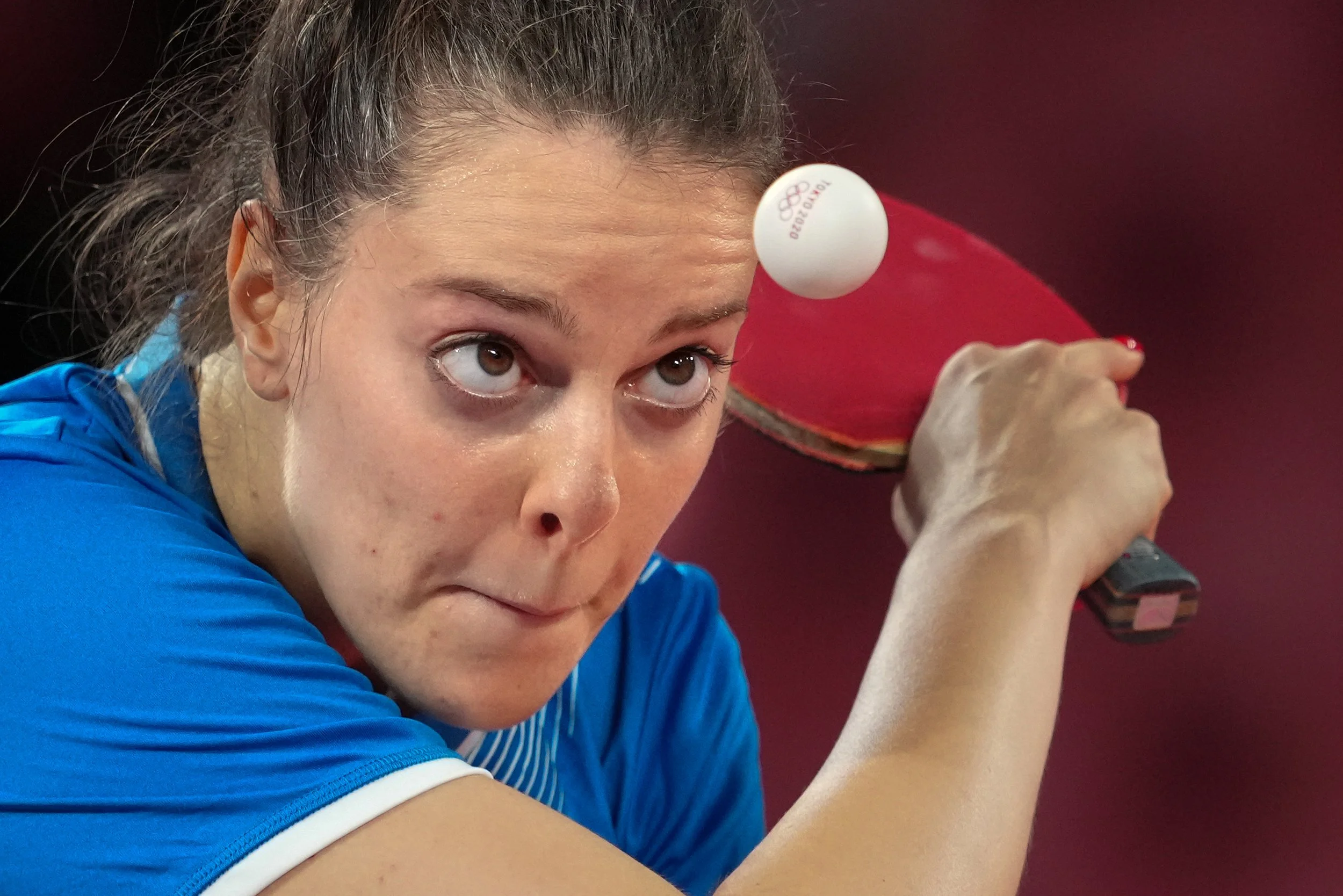 Female table tennis player preparing to hit the ball