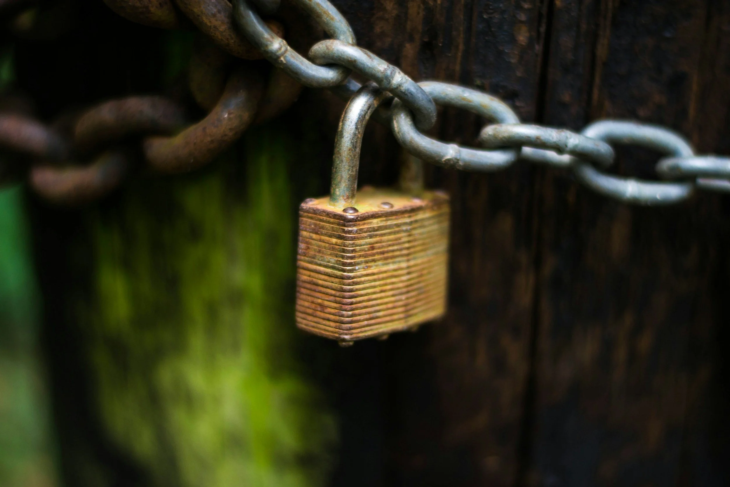 Padlock secured on metal chain representing privacy and confidentiality in a therapy office setting.