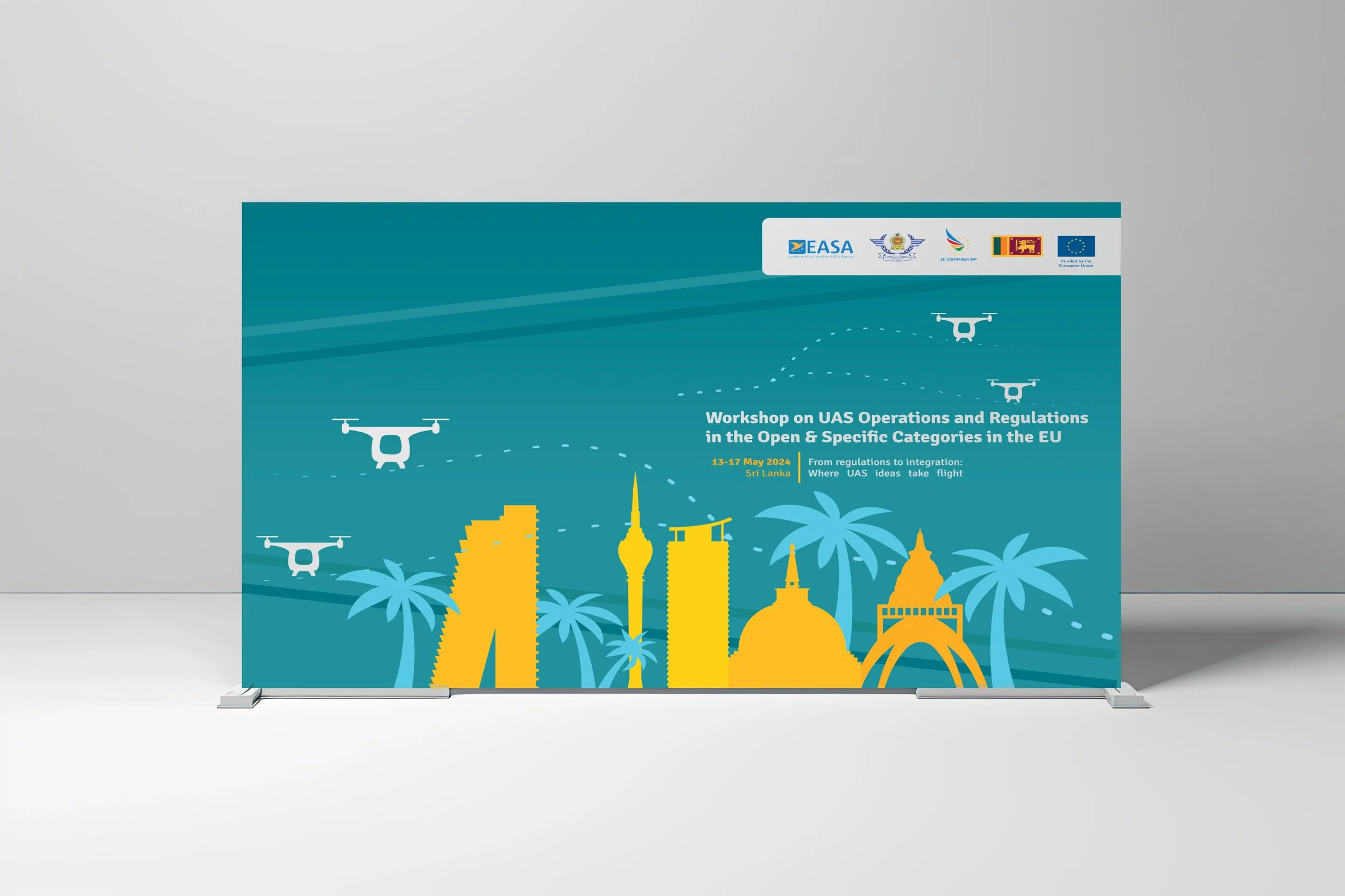 A poster for a workshop on UAS operations and regulations in the EU, featuring depictions of drones flying over a stylized cityscape with palm trees, and logos of organizations including EASA. The event is held from May 13-17, 2024, in Sri Lanka.