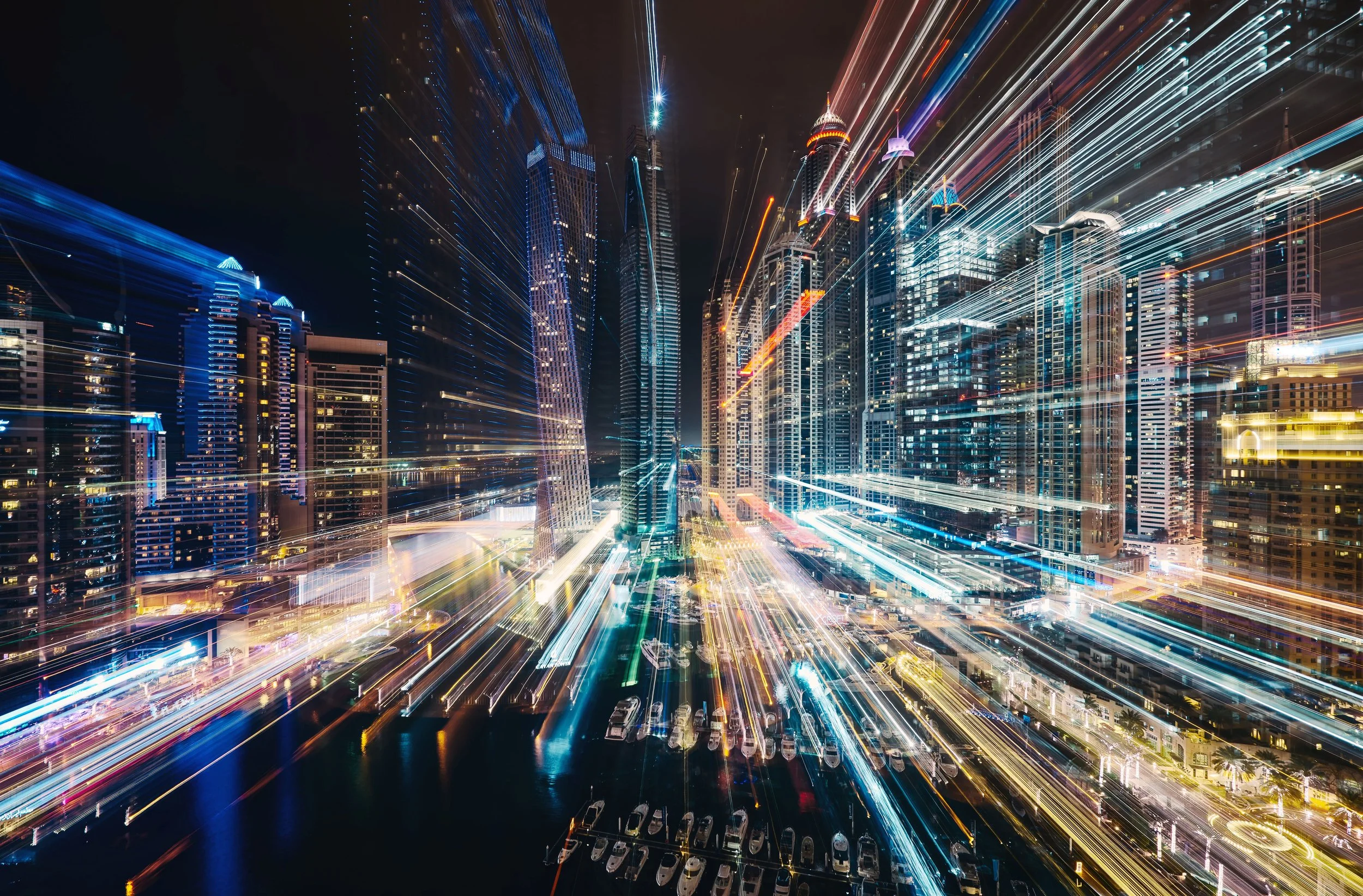 Blurred city lights representing the complexity of modern built environments and the diverse operational challenges faced by asset owners, developers, and operators.