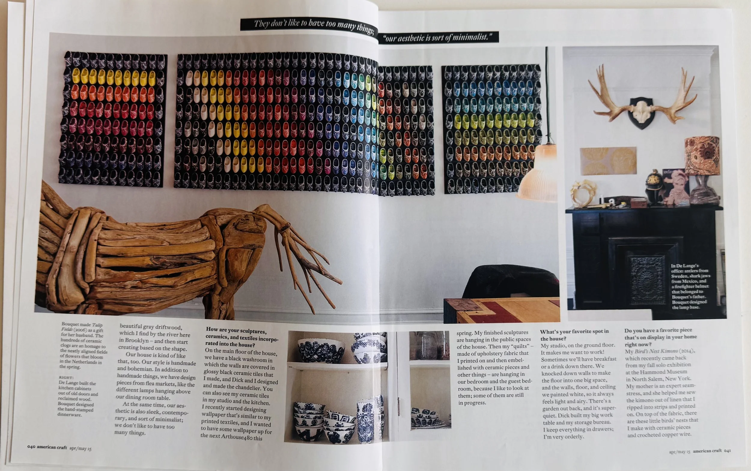 Open magazine spread featuring interior decor, including a wall display of colorful shoes, a wooden sculpture of a deer, and a black fireplace mantel with various decorations and a mounted set of antlers.