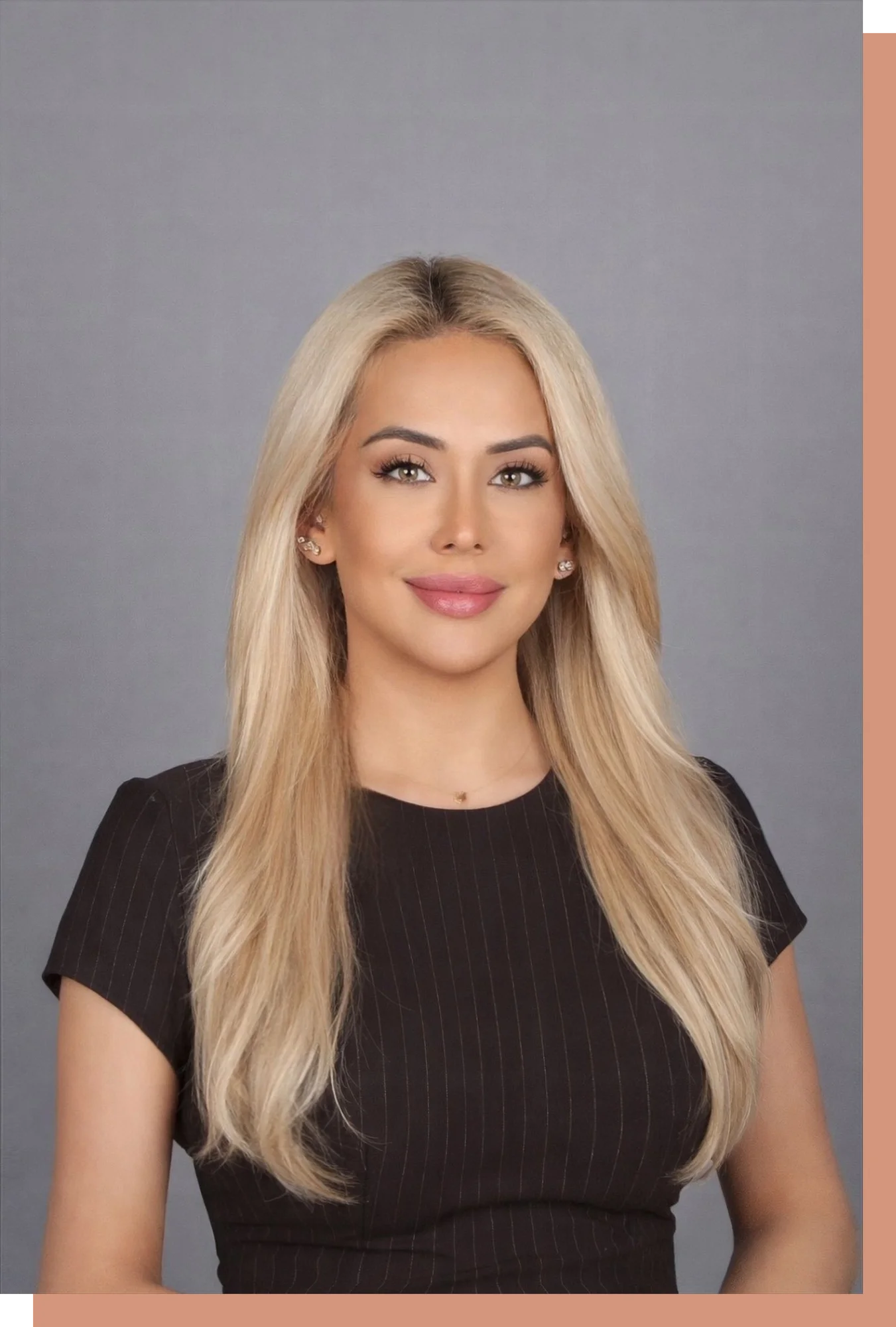 A professional headshot of Merve Ozdas, a woman with long blonde hair, wearing a black pinstriped top, smiling warmly against a neutral grey background.