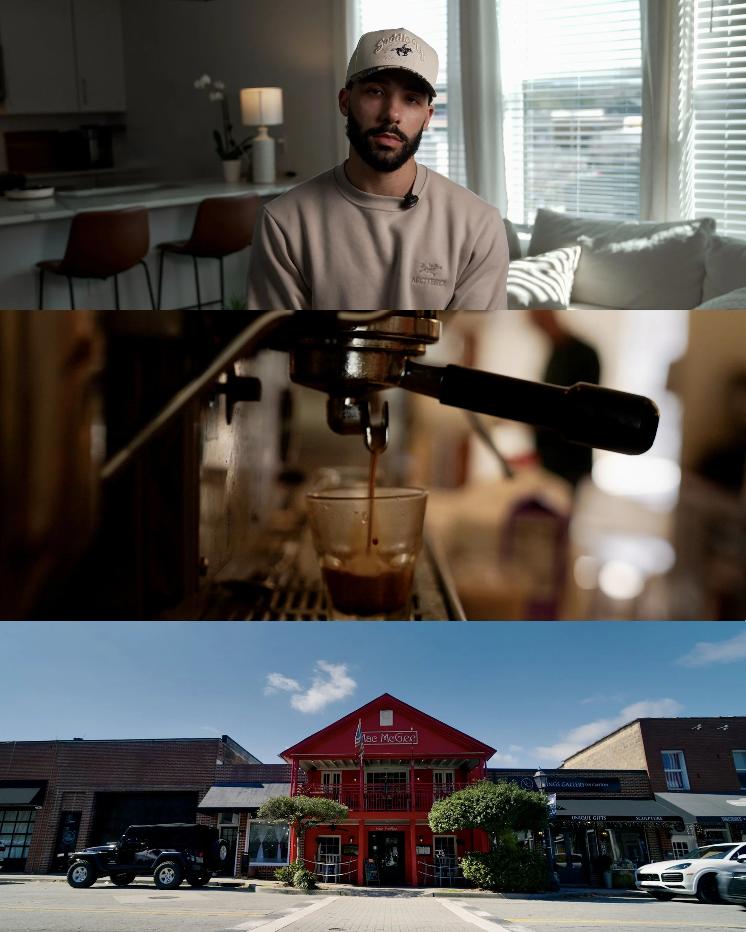 A man with a beard wearing a beige sweatshirt and a white cap with a black horse logo, sitting in a modern living room with large windows, white curtains, and a kitchen with barstools in the background.