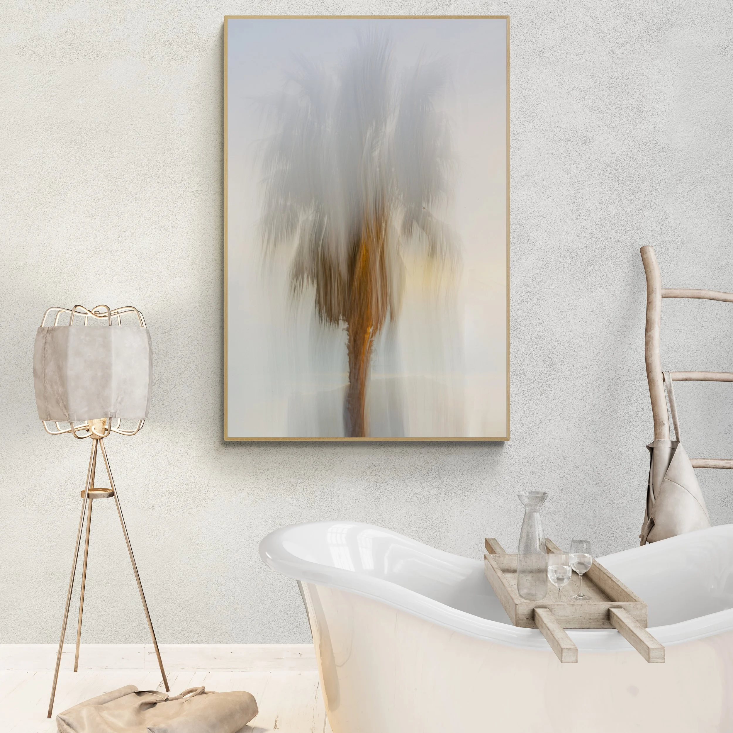 A modern bathroom with a white clawfoot bathtub holding a wooden tray with a glass pitcher and two glasses. Behind the tub, a wooden ladder serves as a towel rack. To the left, a tripod floor lamp with a beige lampshade is present. On the wall, there