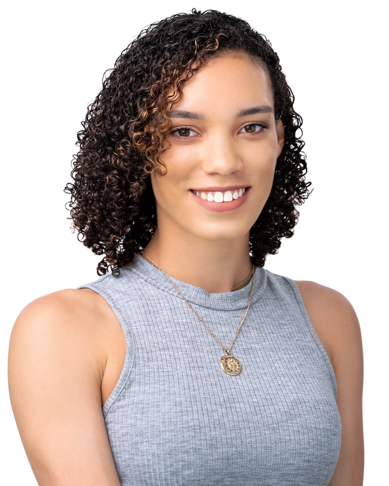 Professional Actor Headshot by Minneapolis Photographer Jay Cupcake. Portrait of a young woman with curly hair, smiling, wearing a gray sleeveless top and a gold necklace.