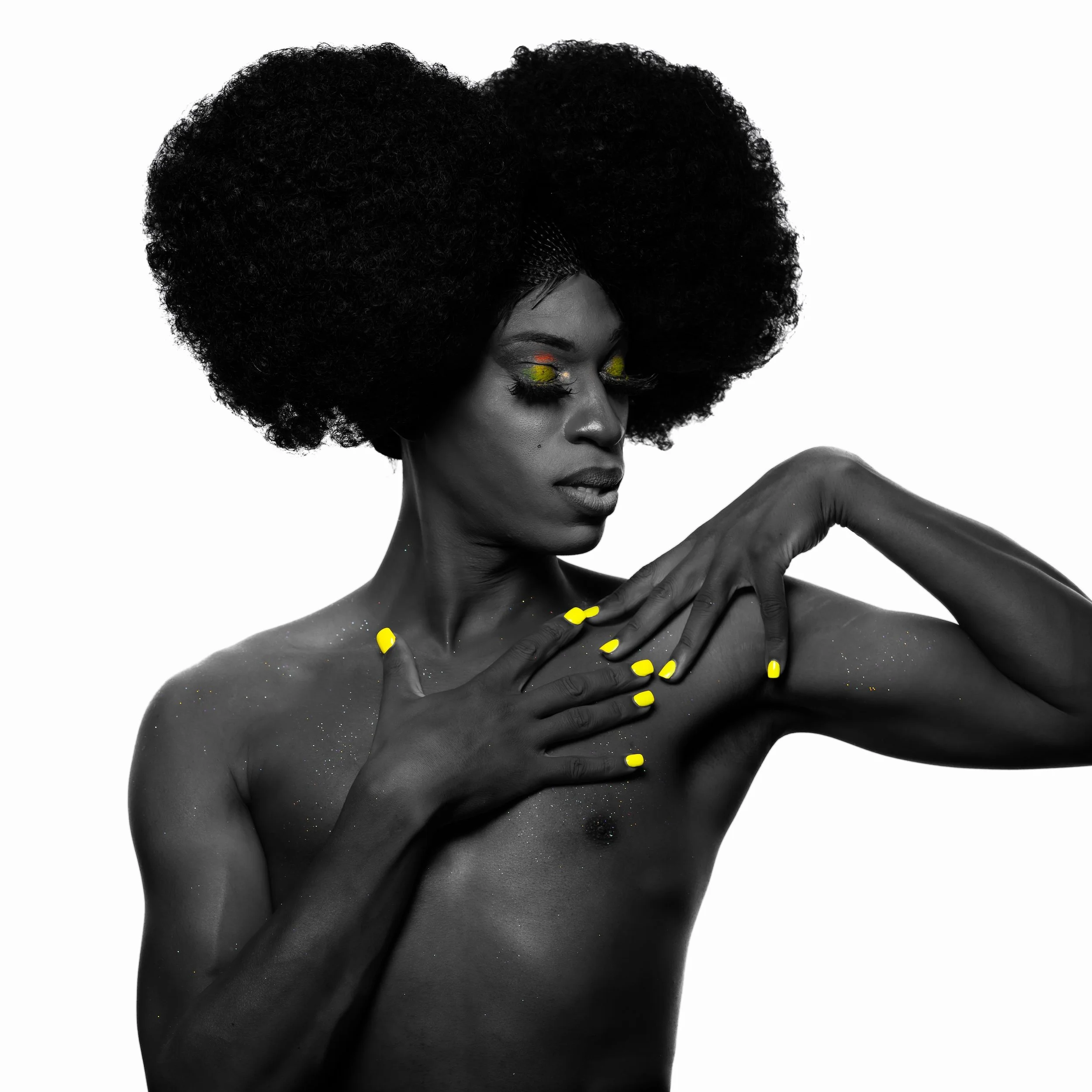 Professional Portrait Photography by Saint Paul Photographer Jay Cupcake. A black and white photo of a woman with an Afro hairstyle, closed eyes, yellow nail polish, and colorful eye makeup, with glitter on her shoulder and face, in a posed artistic 
