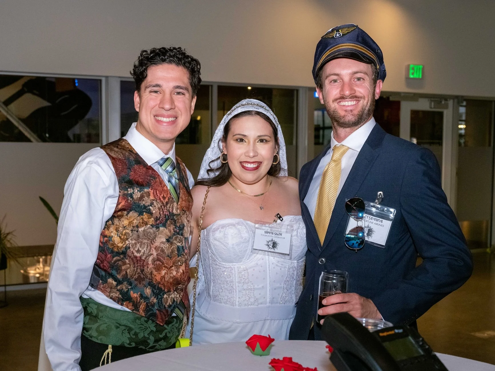 Professional Event Photography by Saint Paul Photographer Jay Cupcake. Three people in wedding attire at a celebration, two men and a woman, smiling and standing close together indoors.