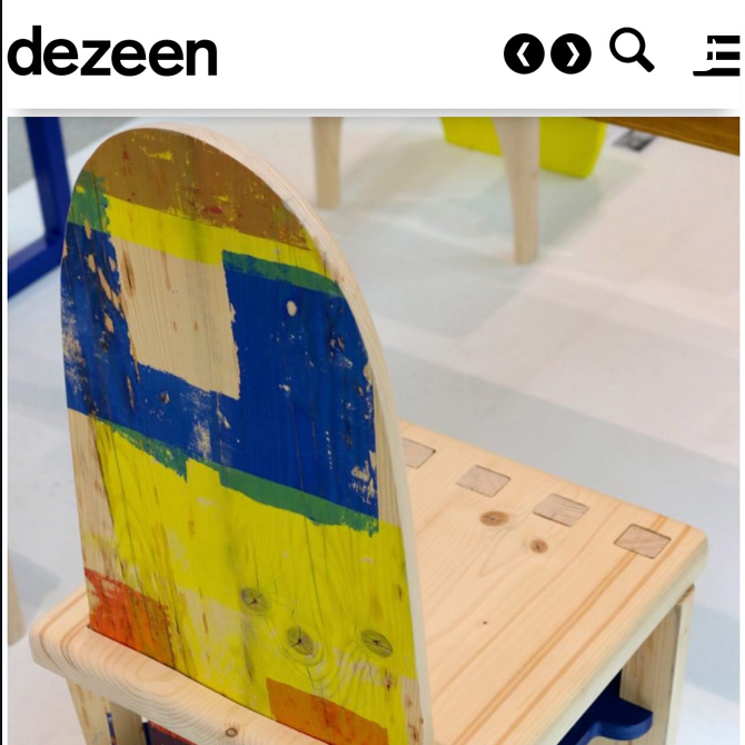 A partially painted wooden chair with a colorful, abstract design on the backrest, featuring blue, yellow, green, and orange paint. Dezeen article covering new designers fair. @katyawaltonstudio instagram post