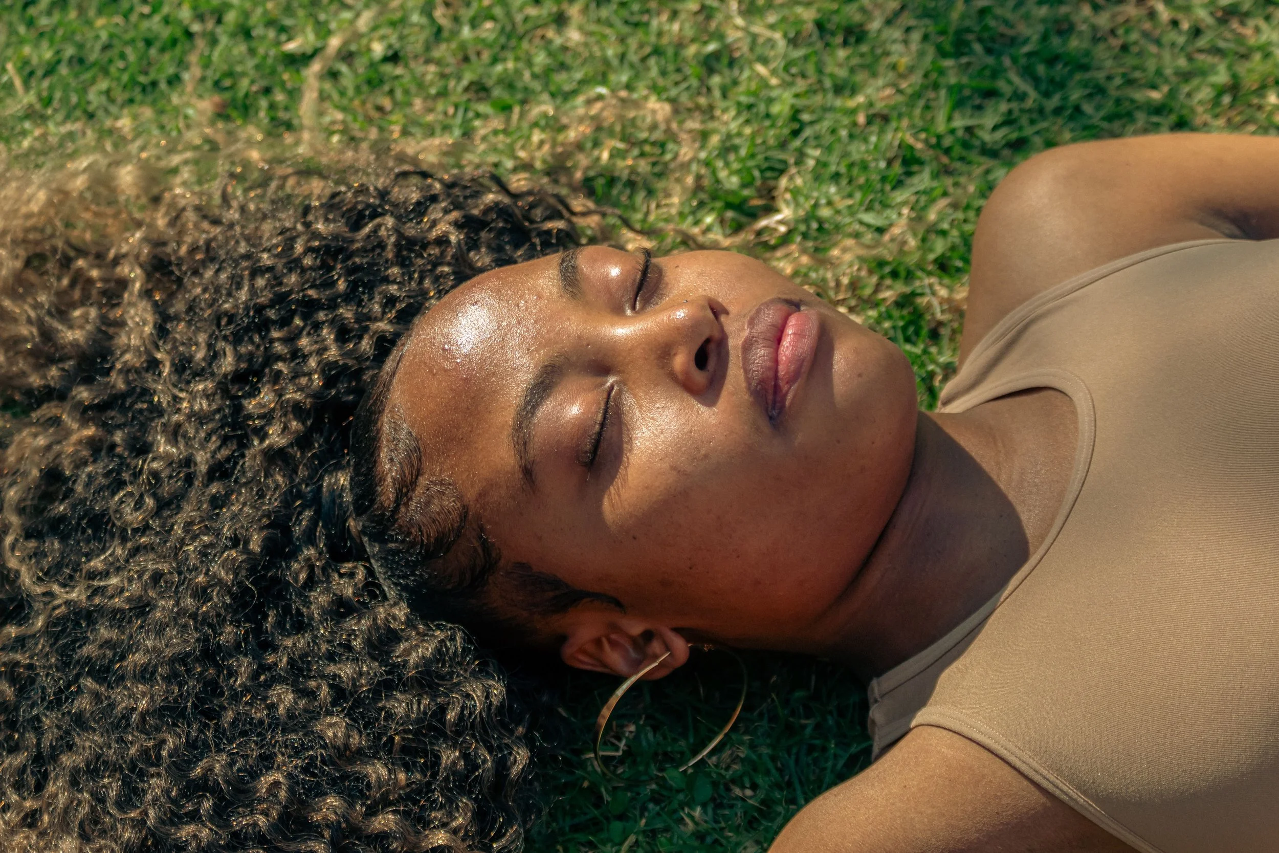 A Black woman in a calm, steady moment, representing the quiet emotional safety that secure attachment produces rather than the intensity often mistaken for chemistry.
