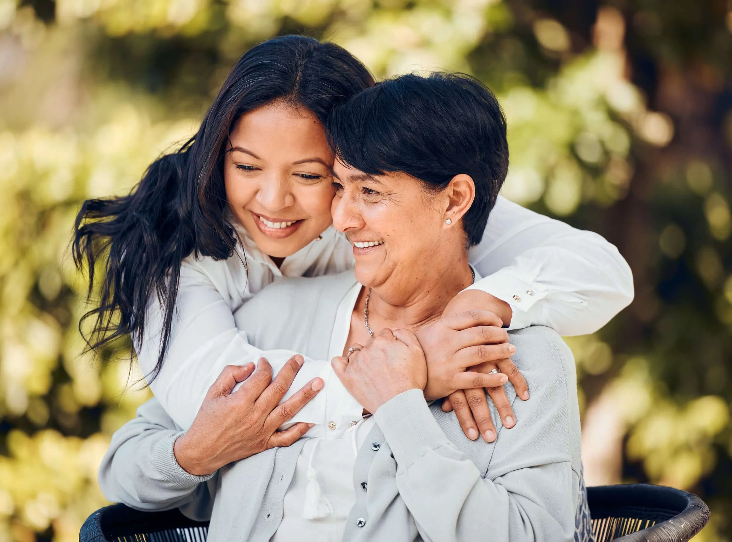 Mother and daughter embracing outdoors