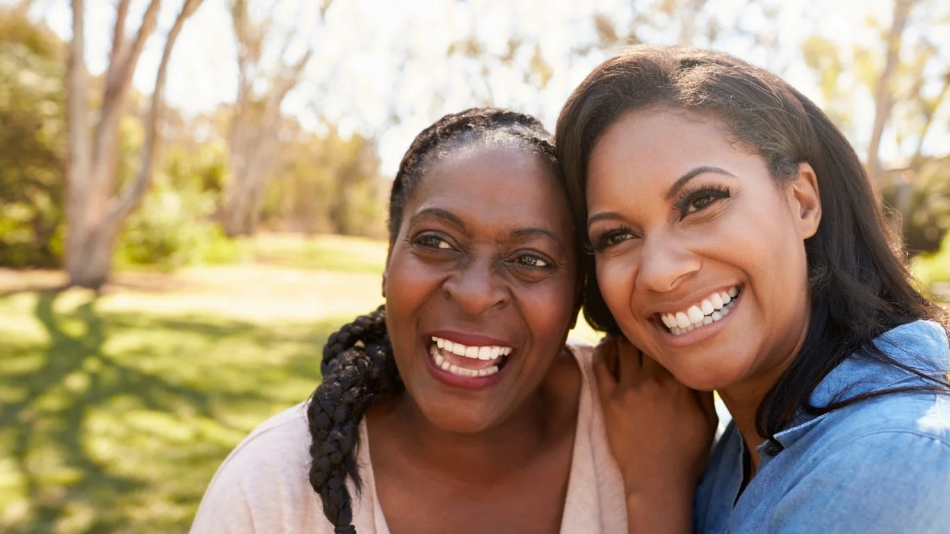 Mother and daughter smiling together taking a selfie