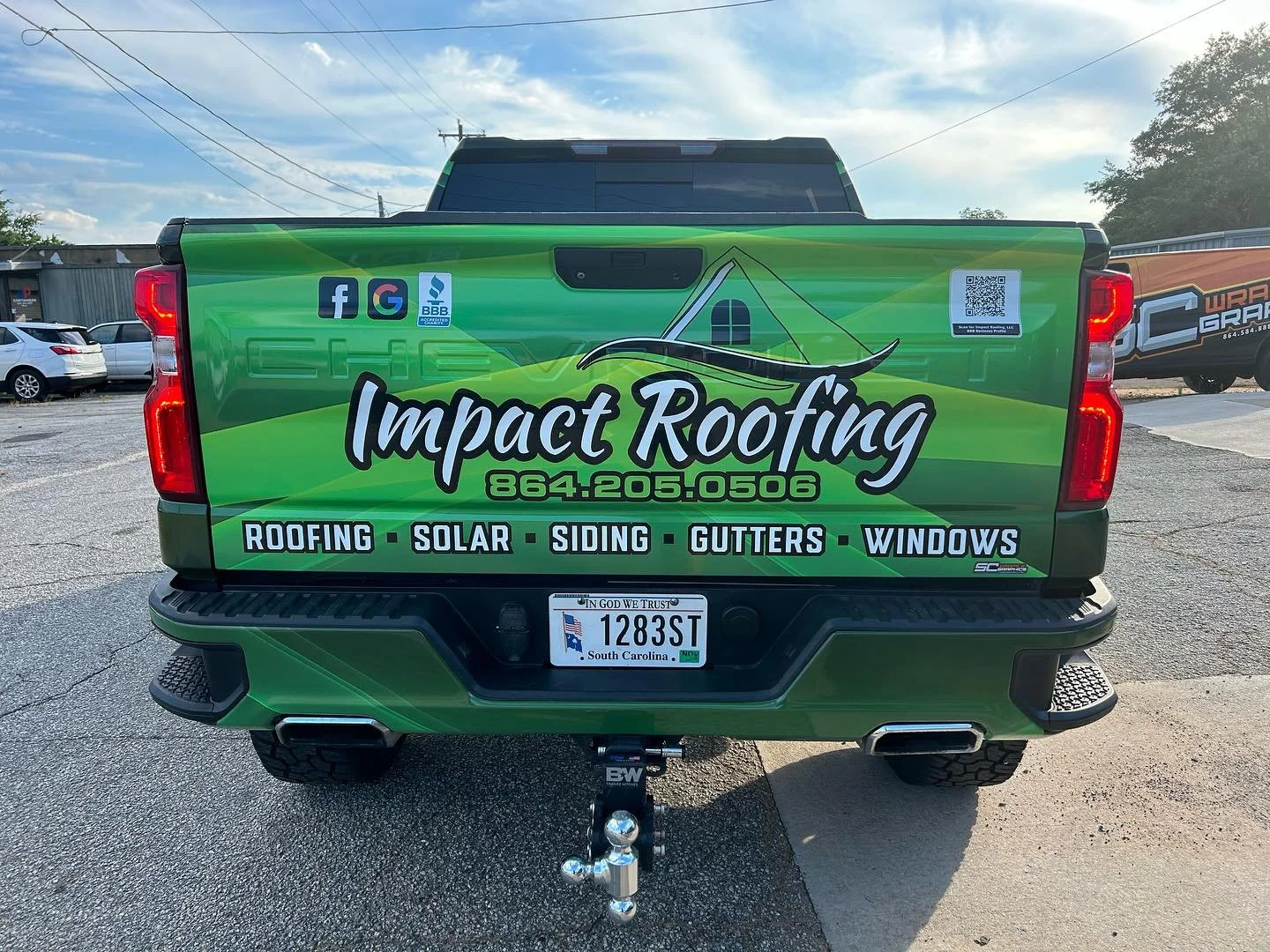 Green truck with Impact Roofing logo, contact number, and services listed including roofing, solar, siding, gutters, and windows.
