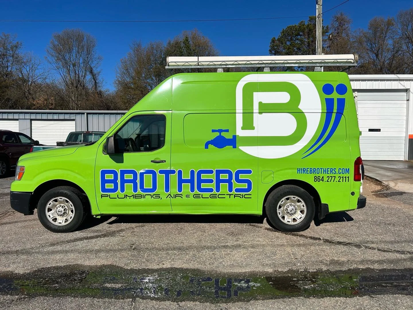 Green service van with blue and white branding for Brothers Plumbing, Air, and Electric, featuring a large logo with a water faucet, the company's website, and phone number.