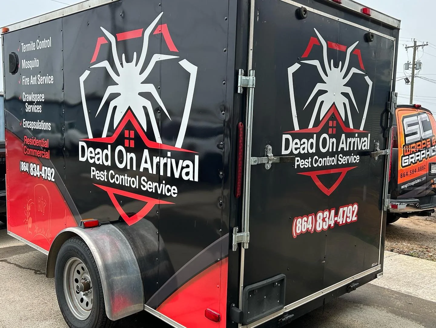 A black and red pest control service trailer with the name 'Dead On Arrival Pest Control Service' and a large spider logo. The trailer lists services, contact number, and features a unique design.