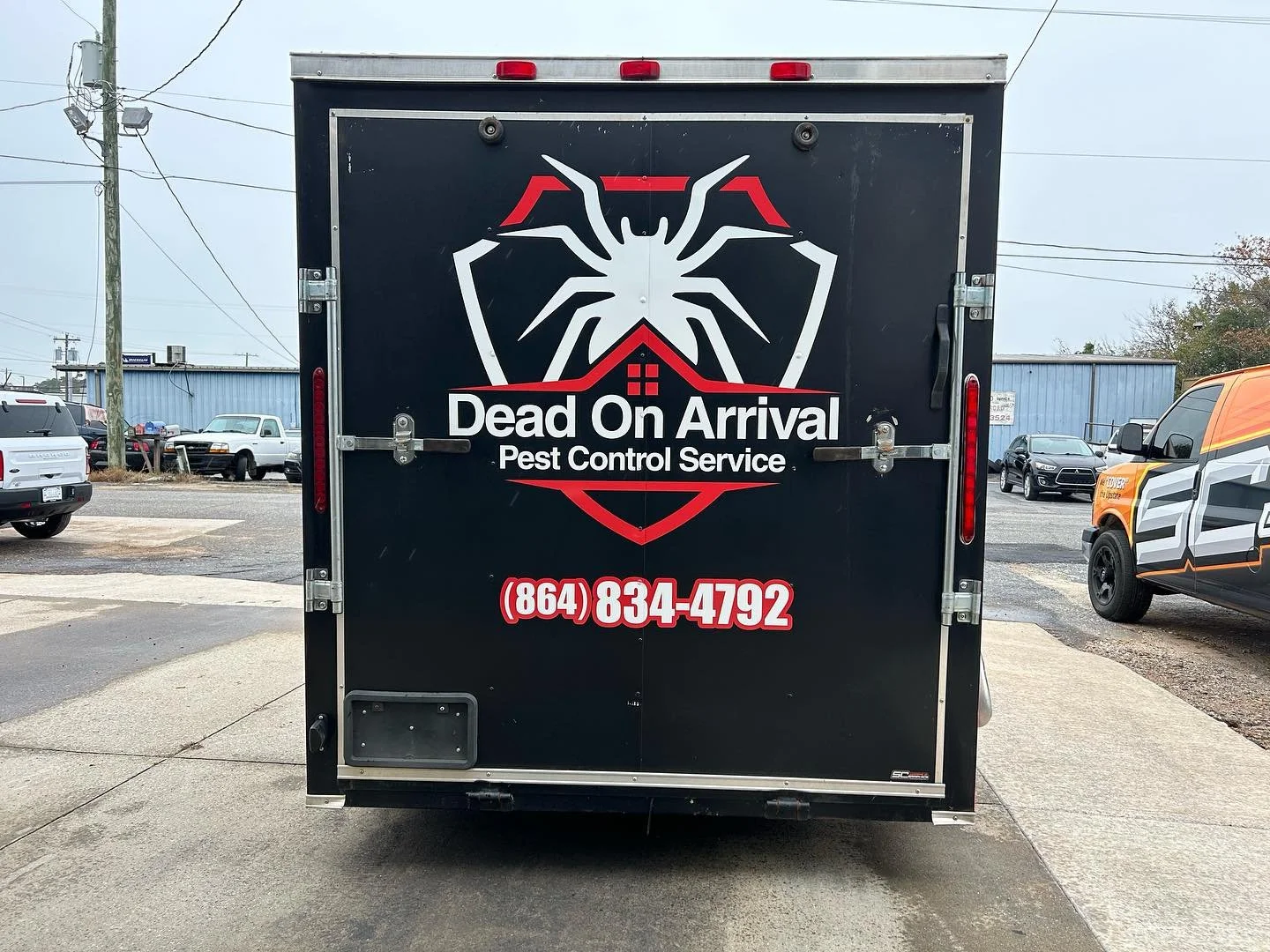Black pest control service truck with a large white spider logo, text 'Dead On Arrival Pest Control Service', and a phone number (864) 834-4792.