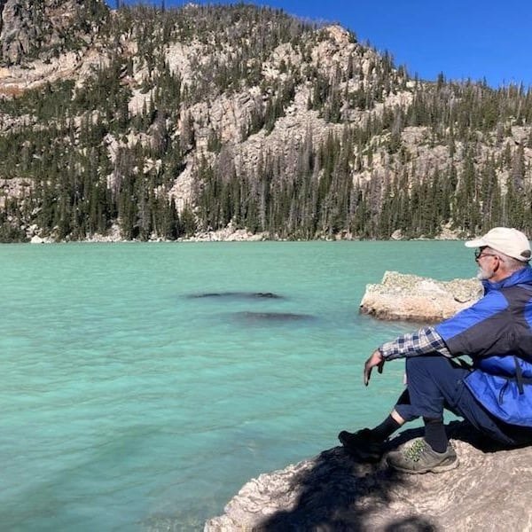 Ken Caldwell musing by mountain lake in Colorado