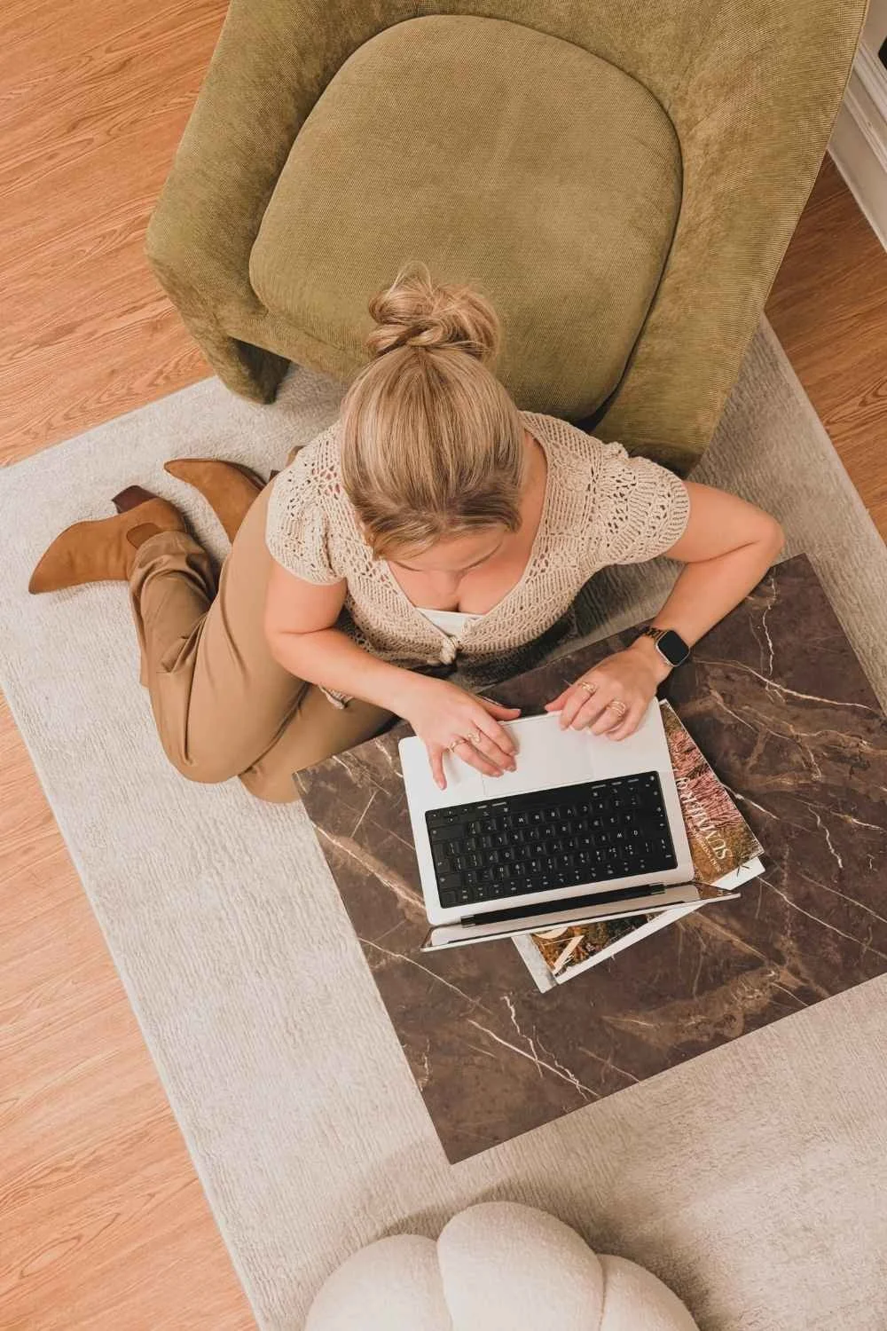 Naysha Gane working on her laptop, viewed from above