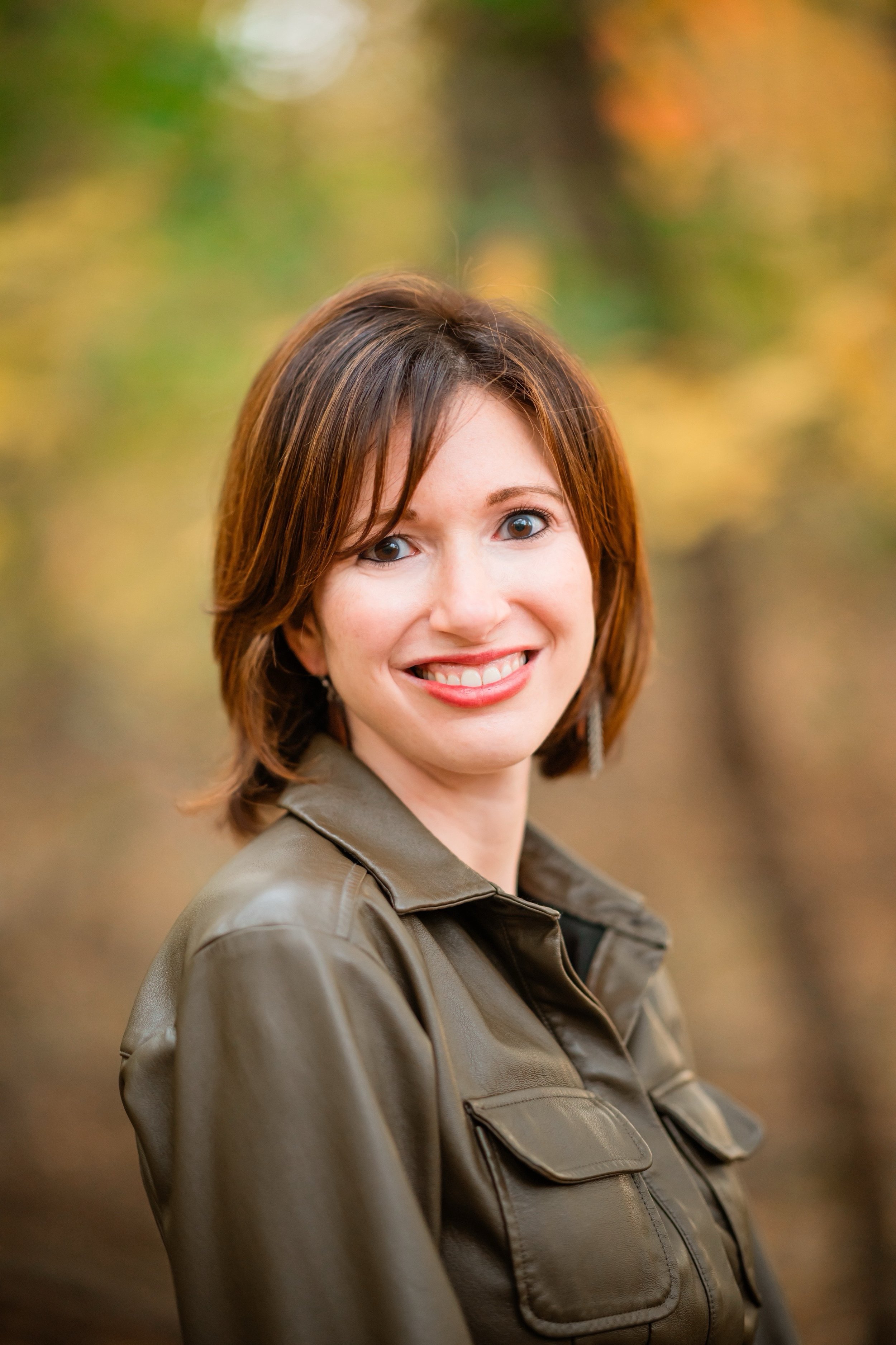 Jenn Roberts Ma, founder of JRM Communications, smiles outside on a fall day.