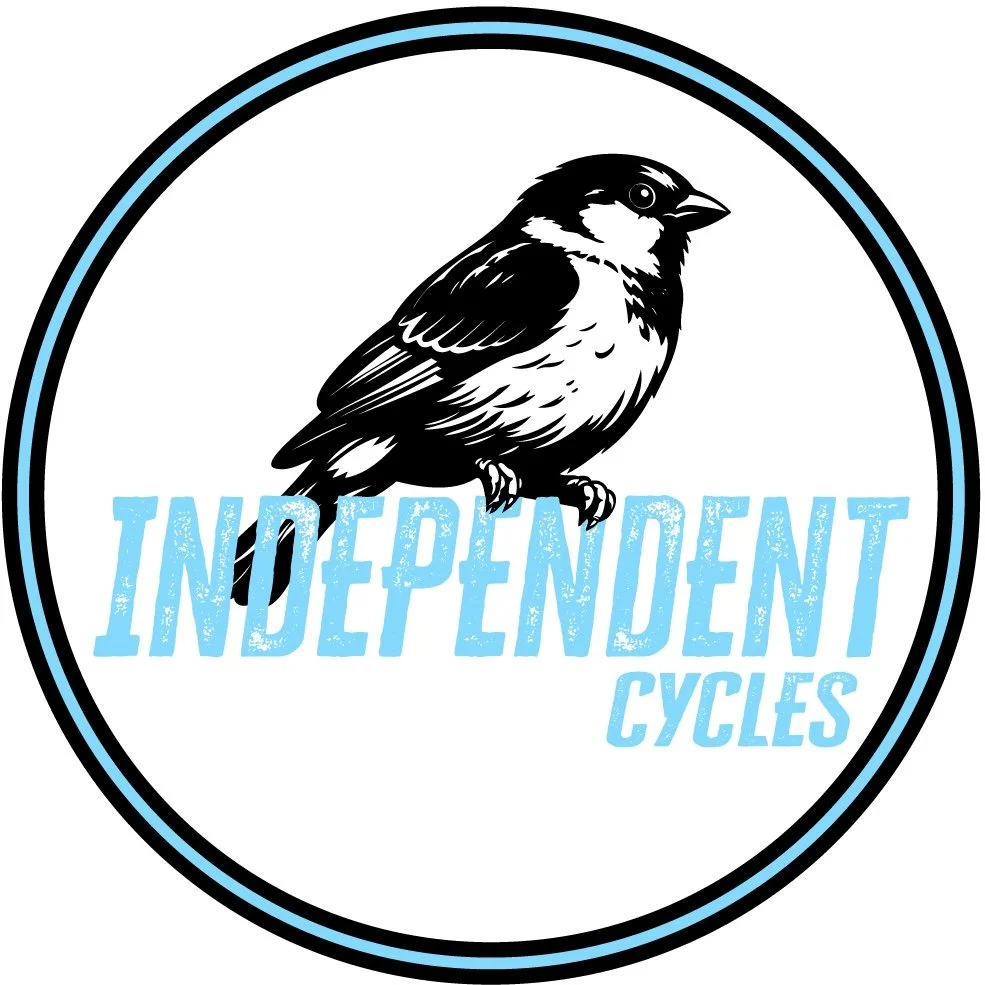 A circular logo featuring a black and white bird perched on top of the words 'Independent Cycles' in blue text.