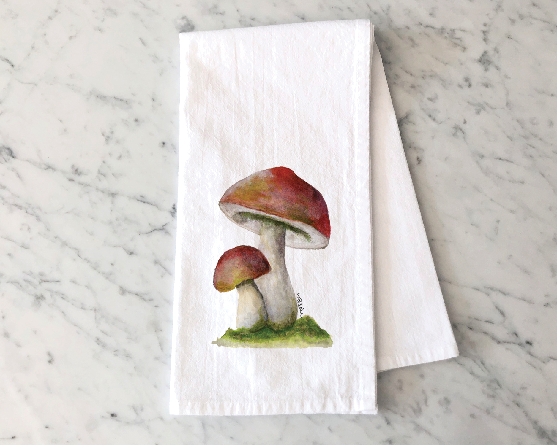 Watercolor painting of three mushrooms with red caps and white stems growing on a small patch of green grass on a marble surface.
