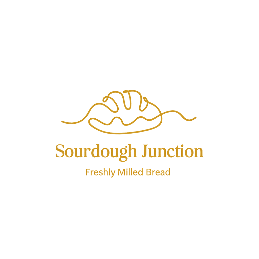 Logo of Sourdough Junction featuring a minimalist line drawing of a loaf of bread with a crusty top, and the text 'Sourdough Junction' and 'Freshly Milled Bread' in gold on a black background.