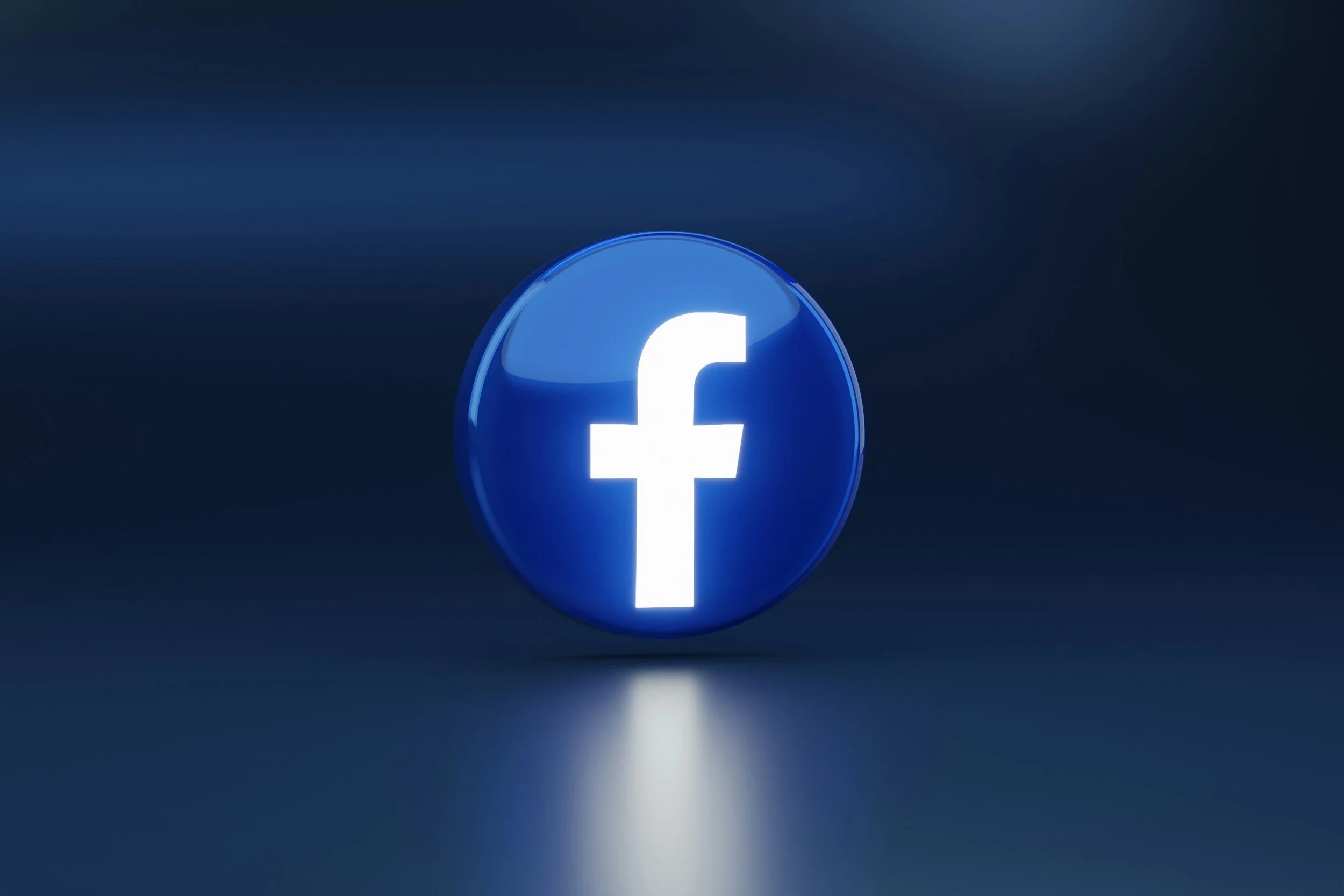 A blue circular icon with a white lowercase 'f' symbol, representing Facebook, on a dark blue background.